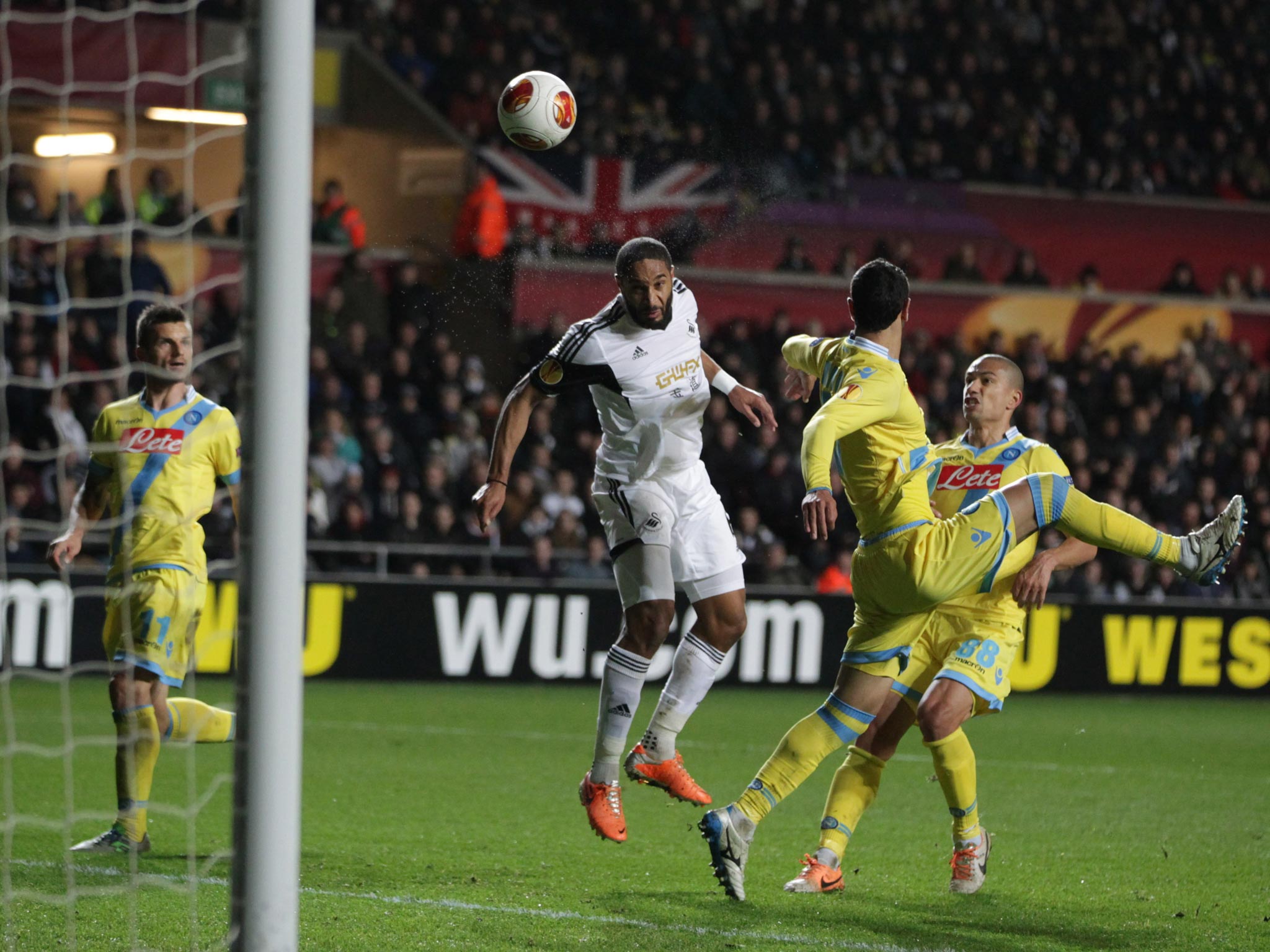 Swansea City's Ashley Williams header is saved by Napoli goalkeeper Pepe Reina (out of shot) during the UEFA Europa League