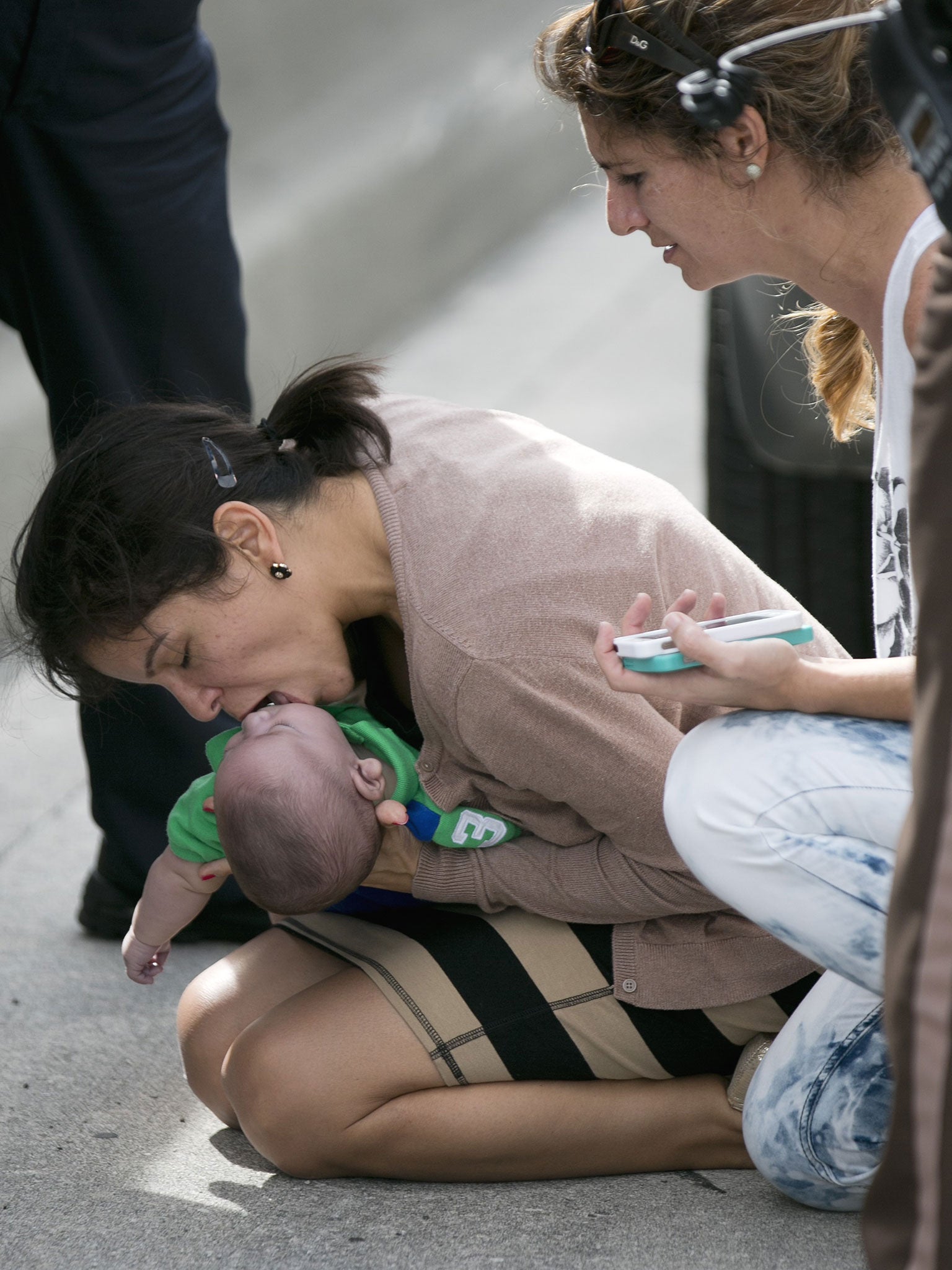 Pamela Rauseo performs CPR on her nephew, five-month-old Sebastian de la Cruz, after pulling her SUV over on the side of the road along the west bound lane on Florida state road 836 just east of 57th Avenue.