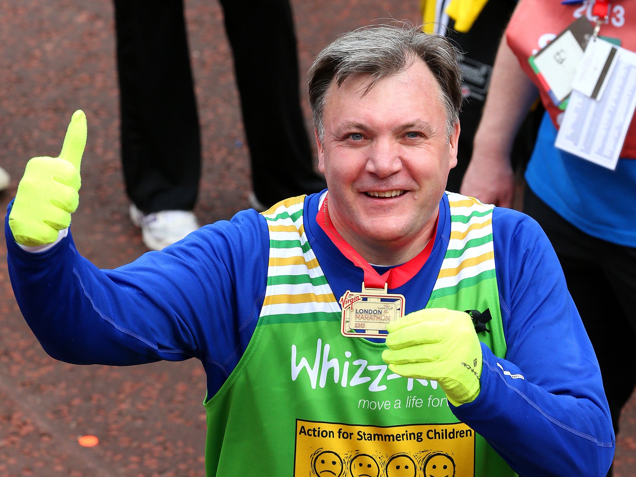 Labour MP and Shadow Chancellor Ed Balls gives a thumbs up as he poses with his medal after the Virgin London Marathon 2013.