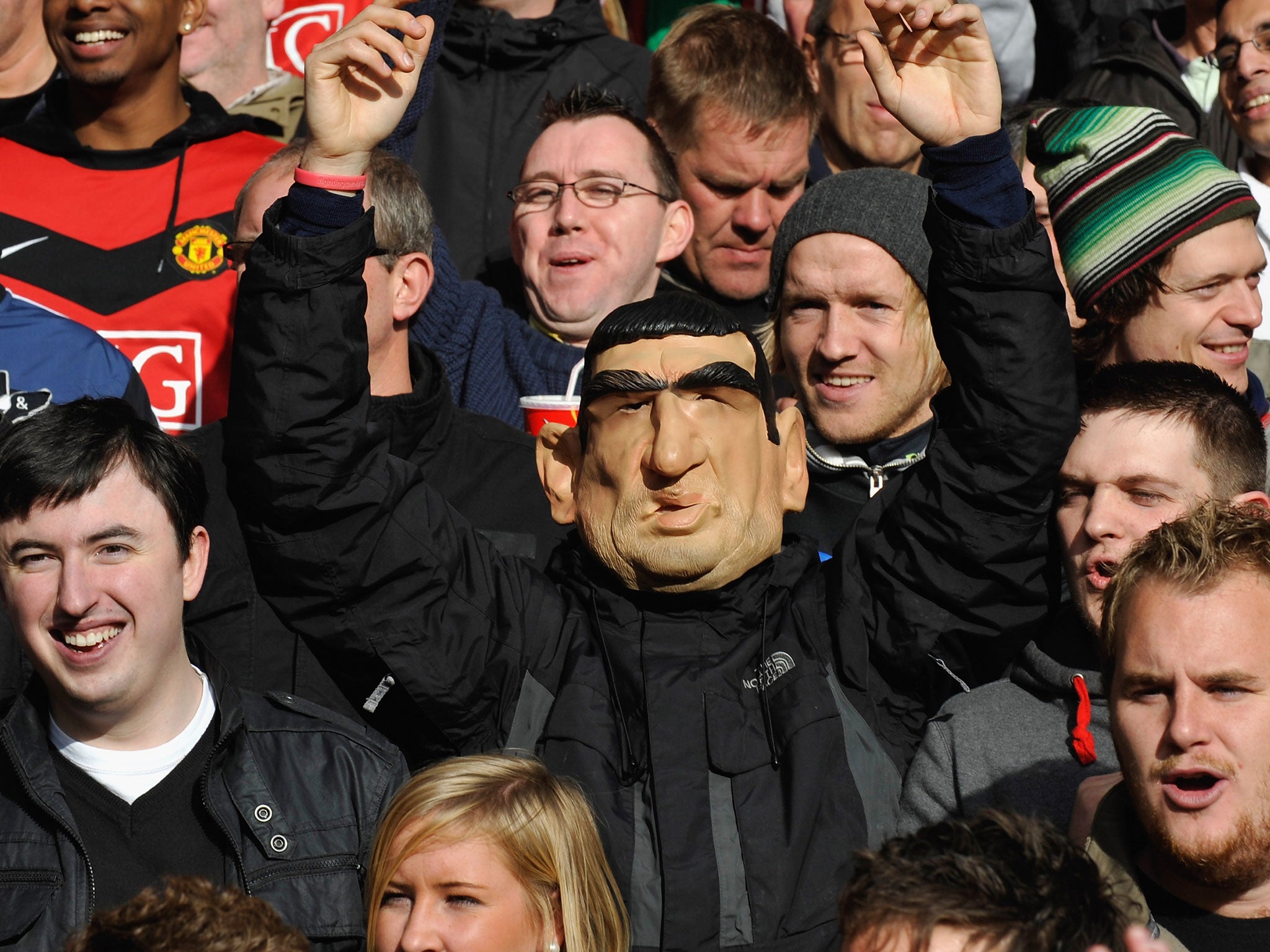 A Manchester United supporter is spotted in the crowd wearing an Eric Cantona mask