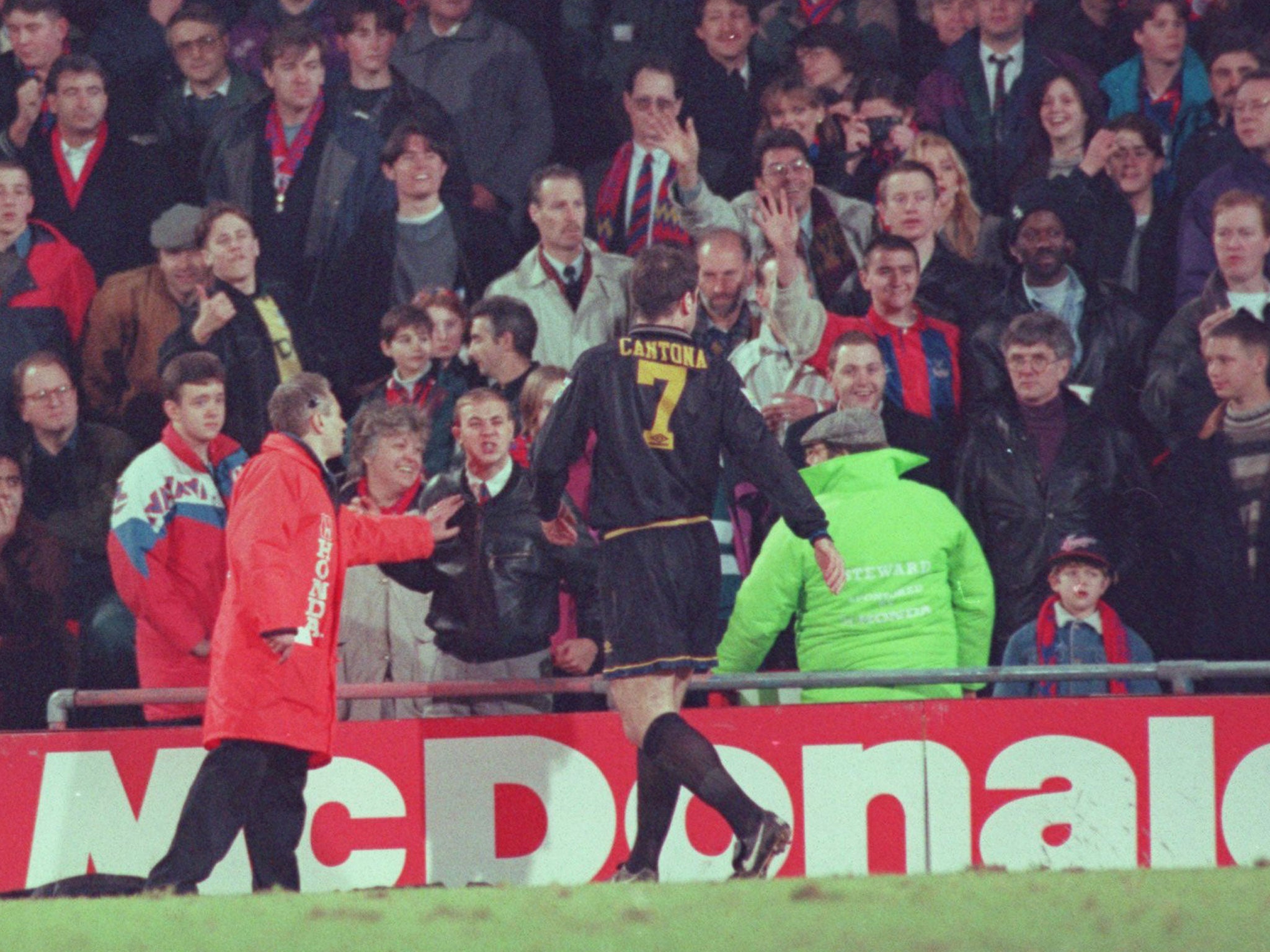 Eric Cantona reacts to abuse from a fan in the Selhurst Park crowd before he launches an attack (GETTY)