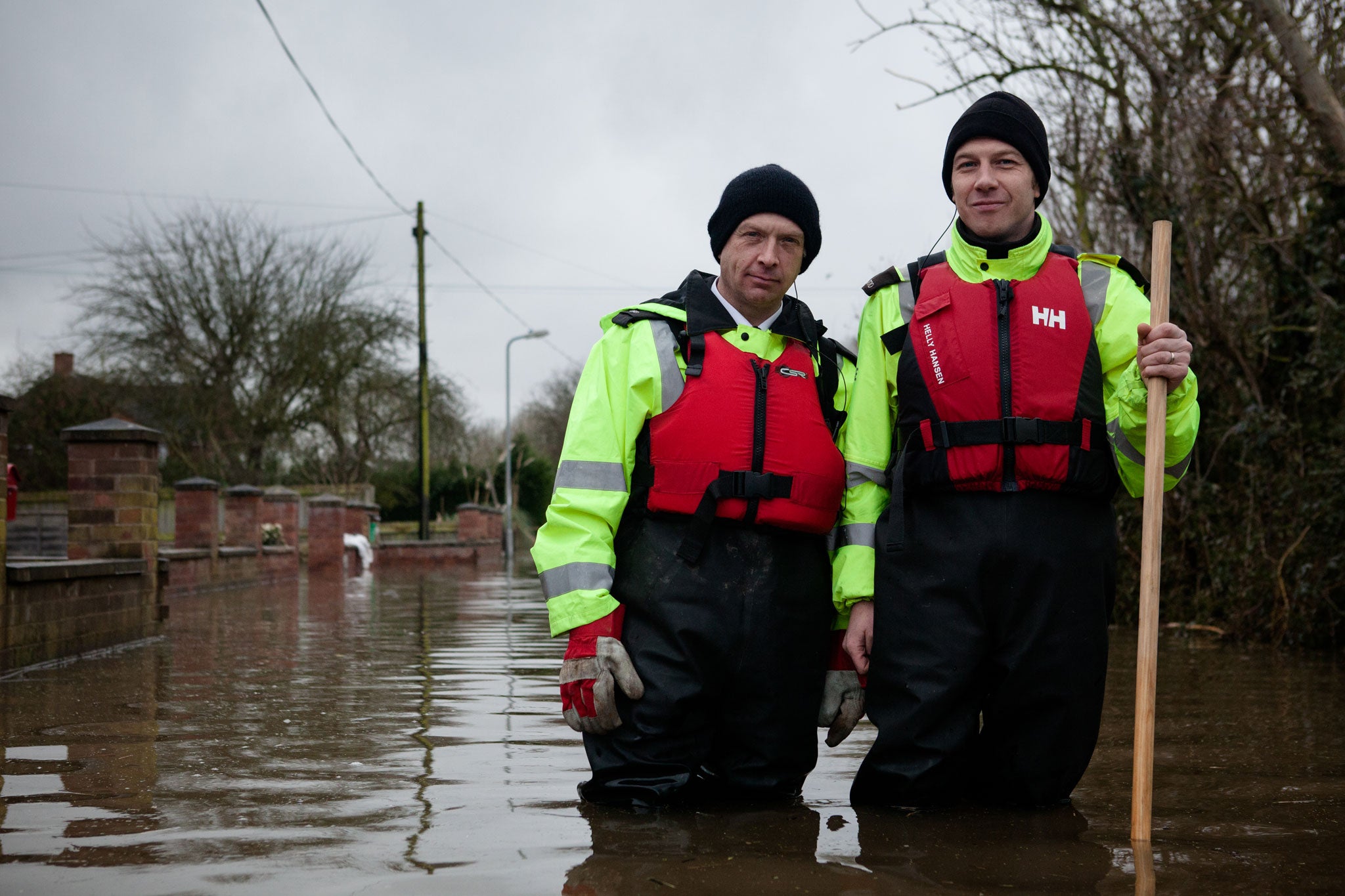 Members of the Avon and Somerset Police visit people still living in their flooded homes
