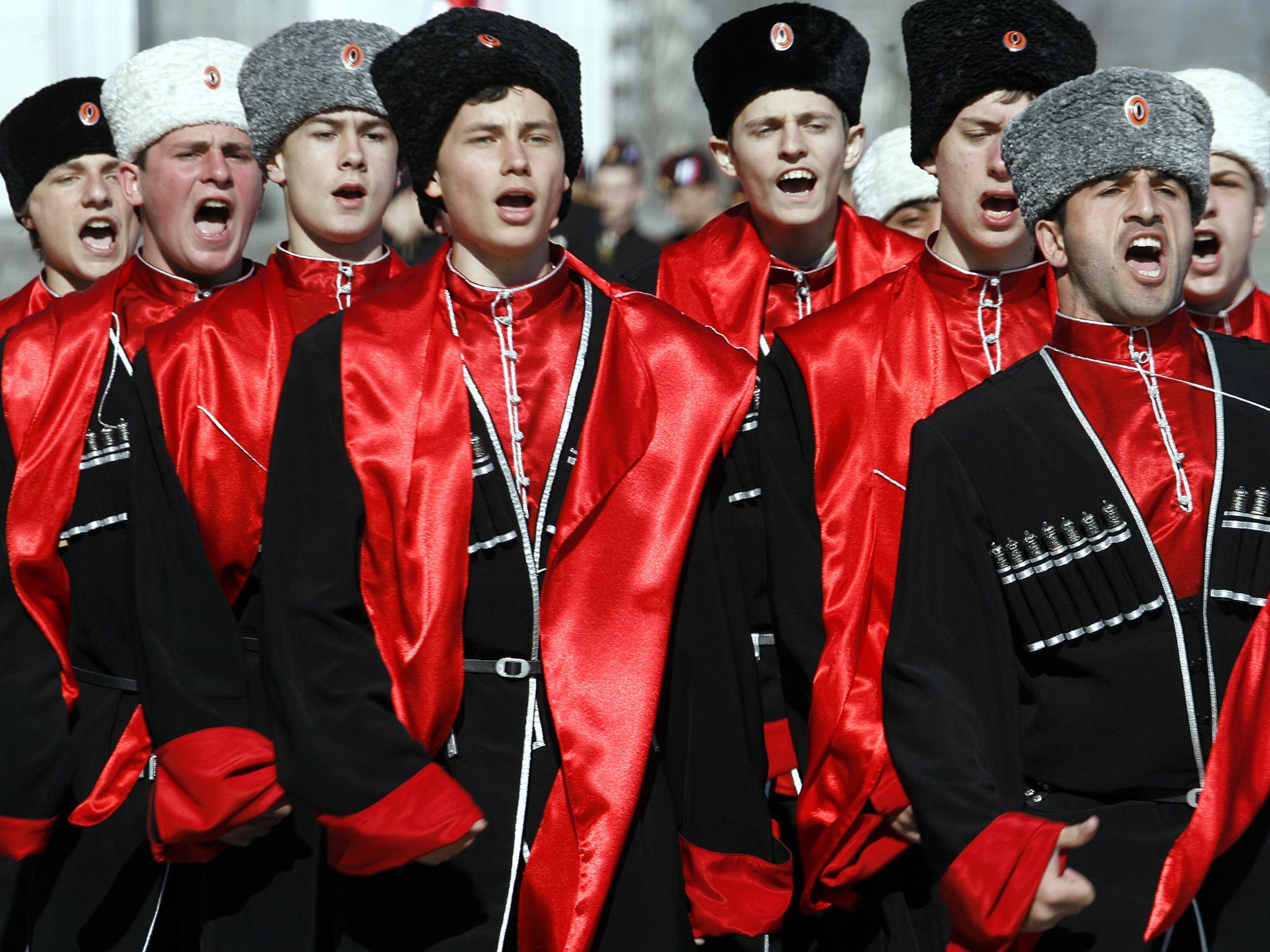 Cadets dressed in Cossack uniform sing as they march during an annual competition