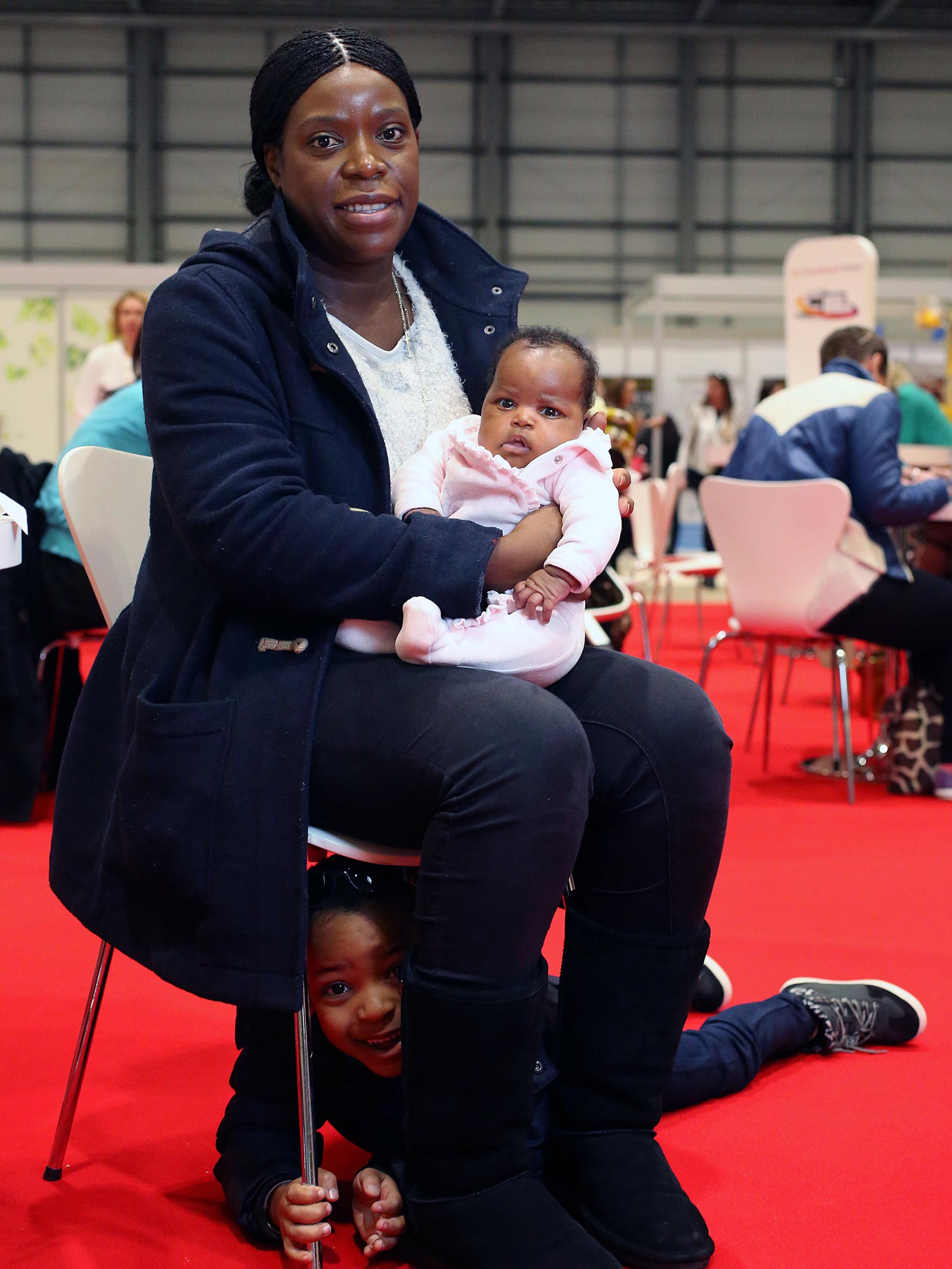 Jeanne Badinge, 30, with her children Thierry, four, and Celine, one
month, at the work and parenting show