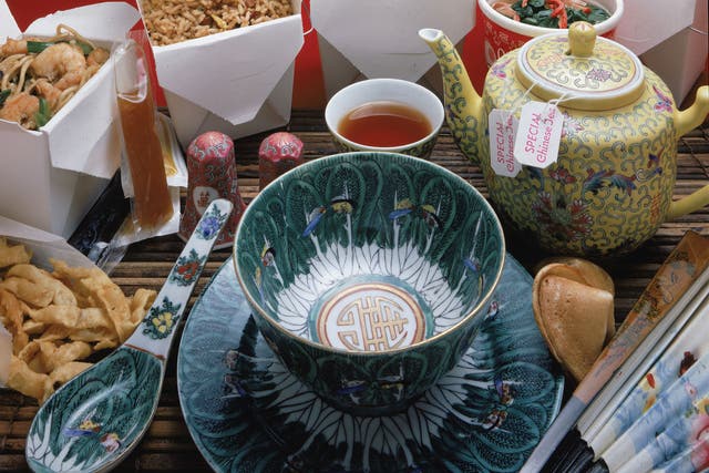 A display of Chinese take-out food and appropriate serving and eating items