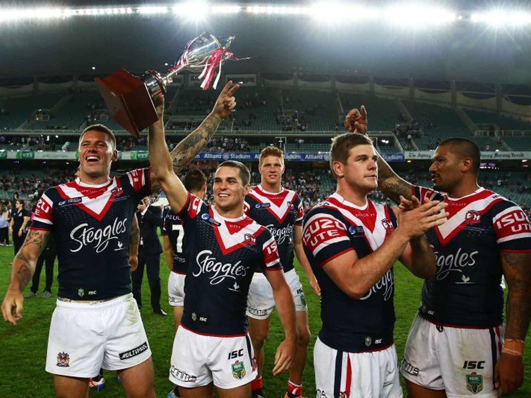 League of their own: Daniel Mortimer lifts the trophy after Sydney’s win