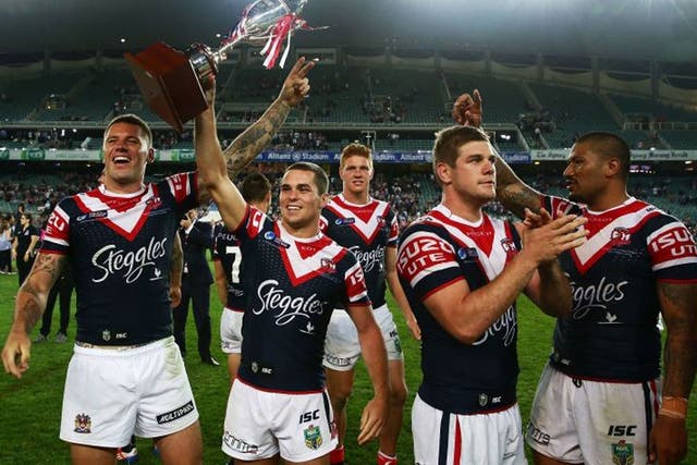 League of their own: Daniel Mortimer lifts the trophy after Sydney’s win 