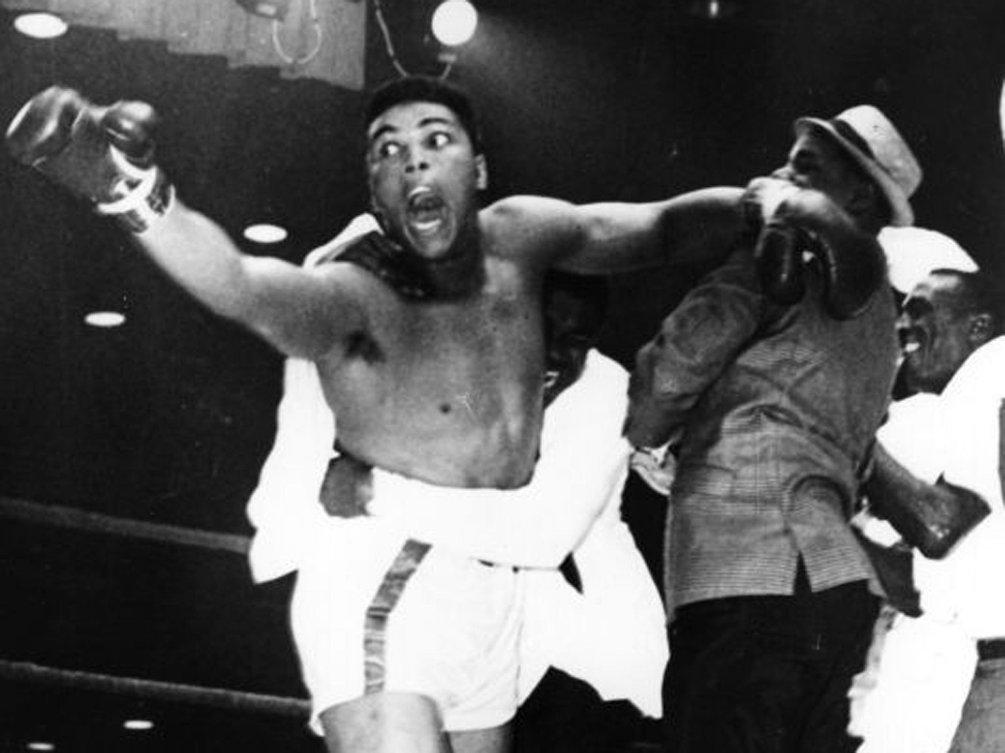 Muhammad Ali celebrating after defeating the Mafia-run, seemingly invincible ogre Sonny Liston in Miami