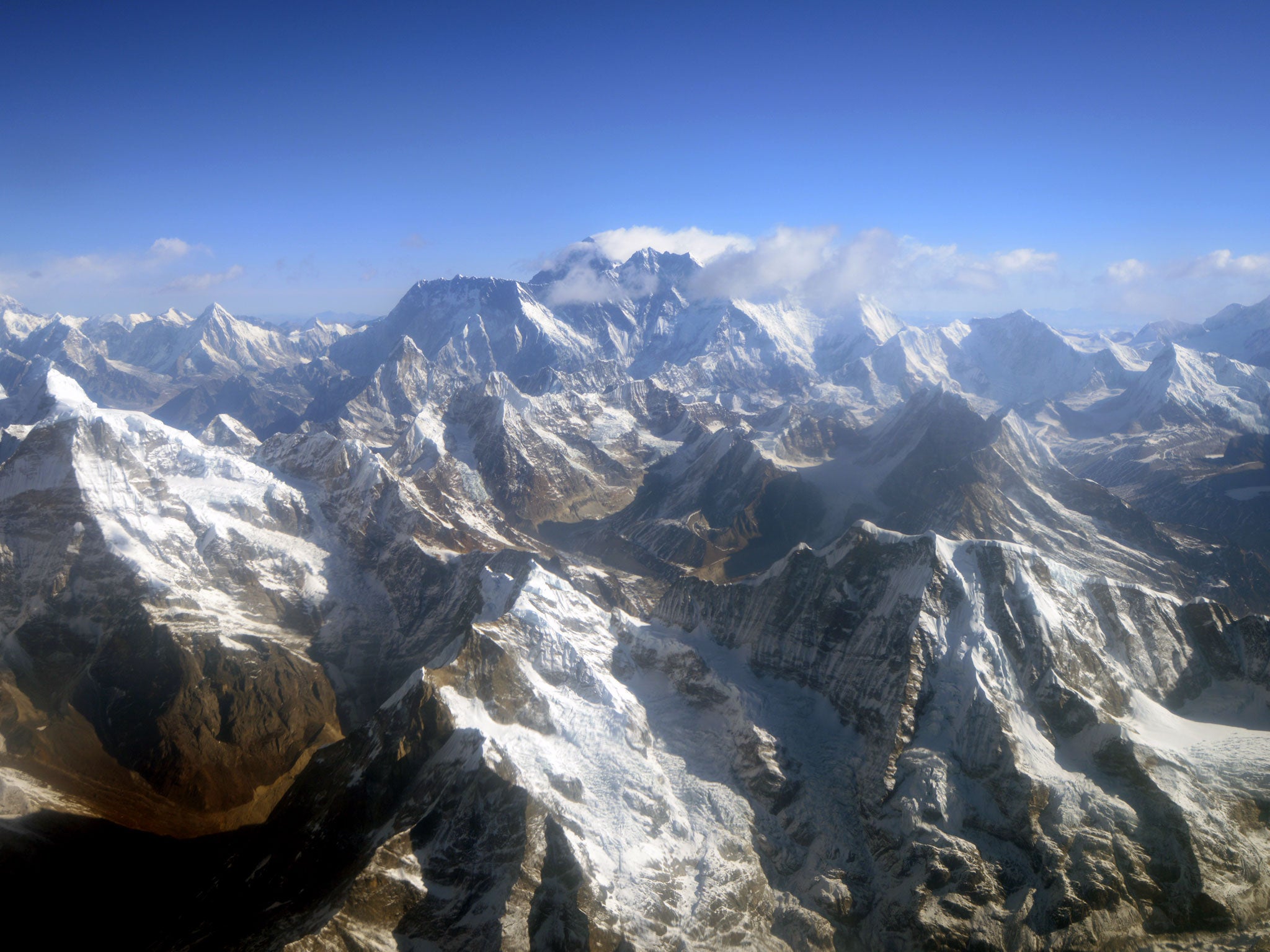 This photograph taken from an aircraft shows an aerial view of Mount Everest (C) and The Himalayan mountain range, some 140kms (87 miles) north-east of Kathmandu on April 3, 2013, on the 80th anniversary of the first manned flight over Mount Everest, the