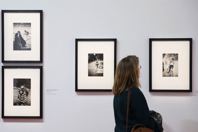 A woman looks at a photo by Henri Cartier-Bresson on the opening day of the retrospective dedicated to the French photographer