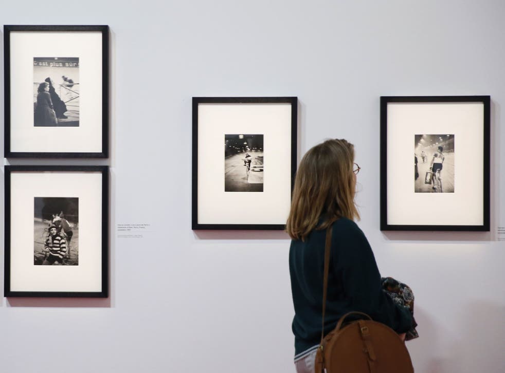 A woman looks at a photo by Henri Cartier-Bresson on the opening day of the retrospective dedicated to the French photographer