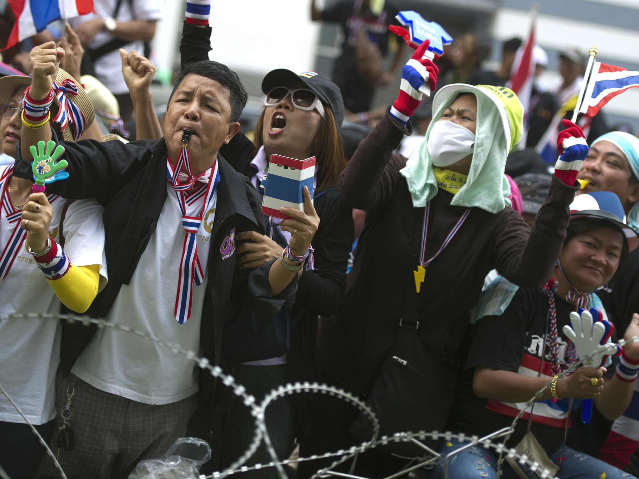 Thai anti-government protesters shout slogans outside the government's temporary office.