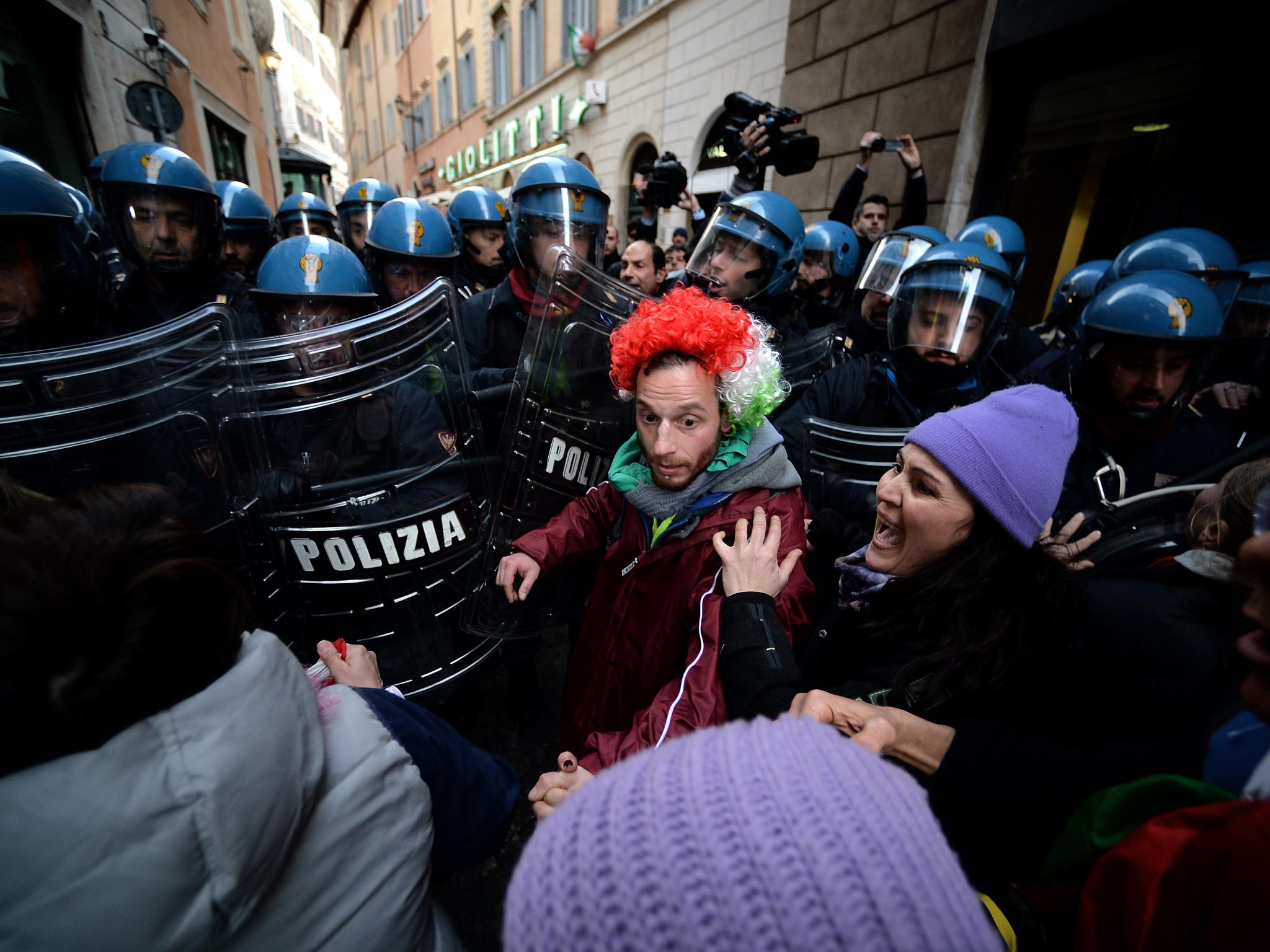 Demonstrators clash with riot police during a protest near the Italian parliament in Rome