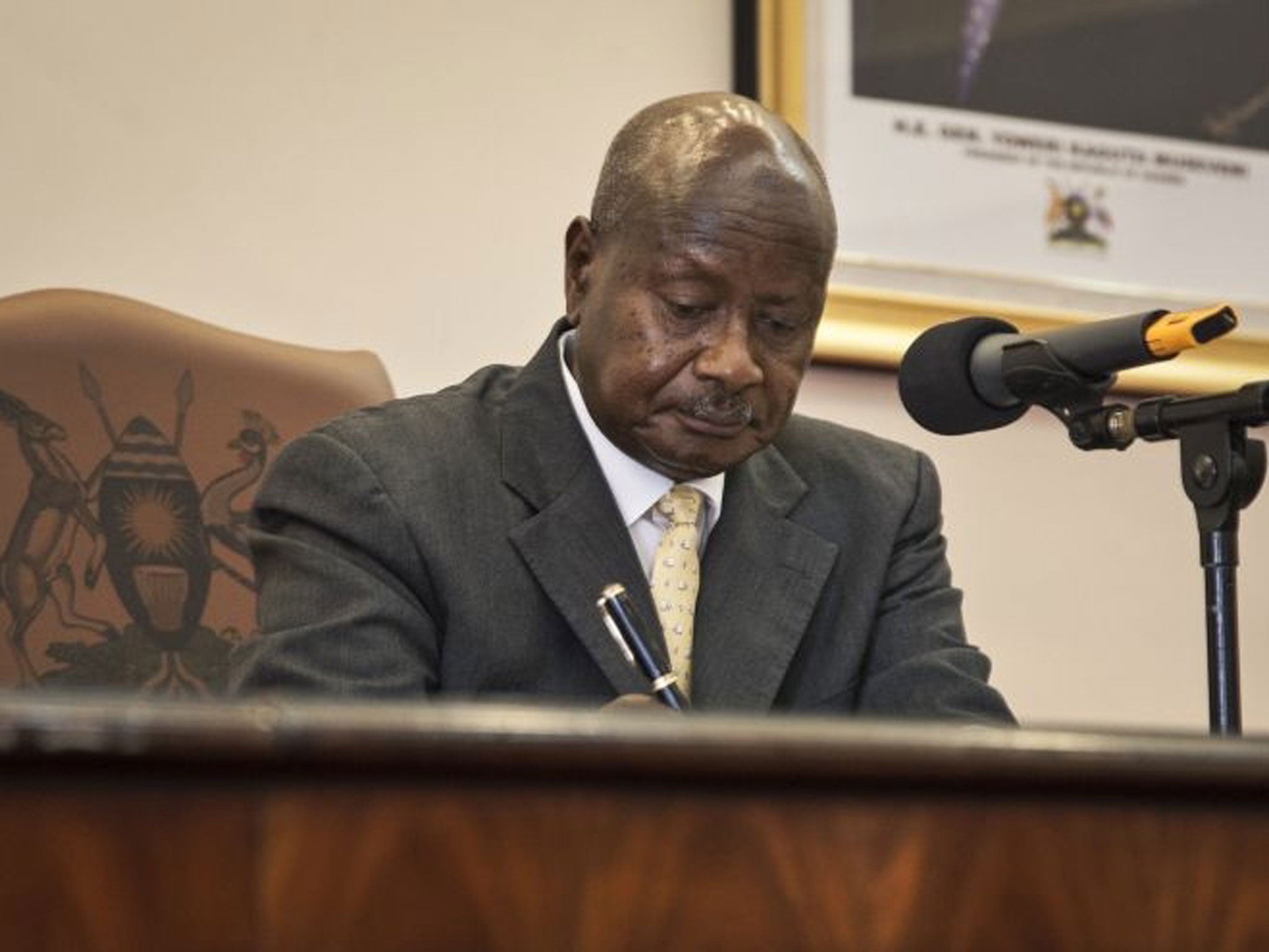Uganda's President Yoweri Museveni signs a new anti-gay bill that sets harsh penalties for homosexual sex, in Entebbe, Uganda.