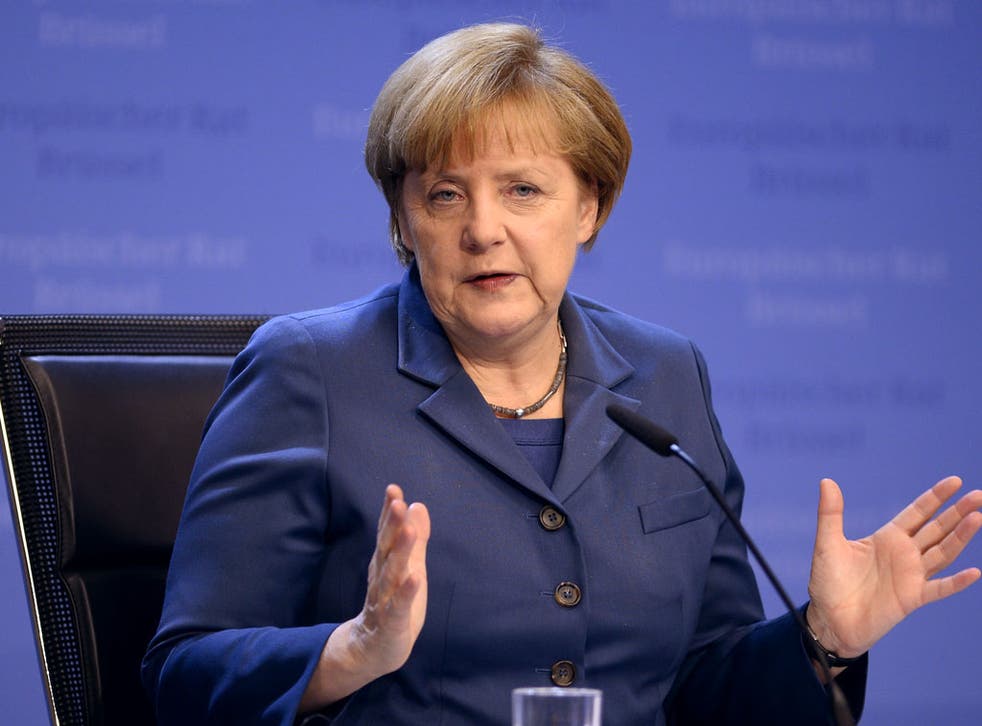 German Chancellor Angela Merkel gives a press conference as part of an EU summit focused on the common security, Defence policy and Economic and Monetary union, in Brussels on December 19, 2013. 