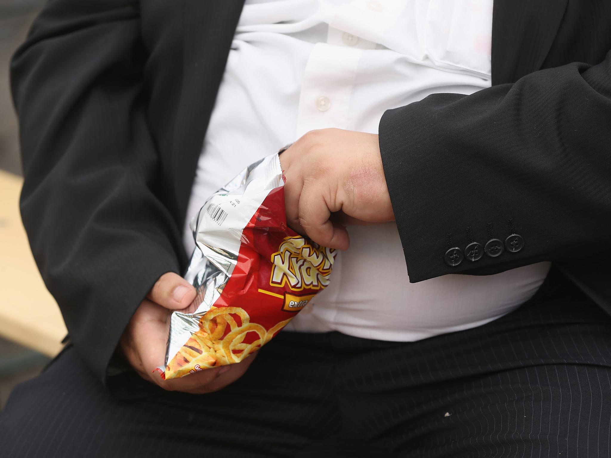 A man eats a packet of crisps