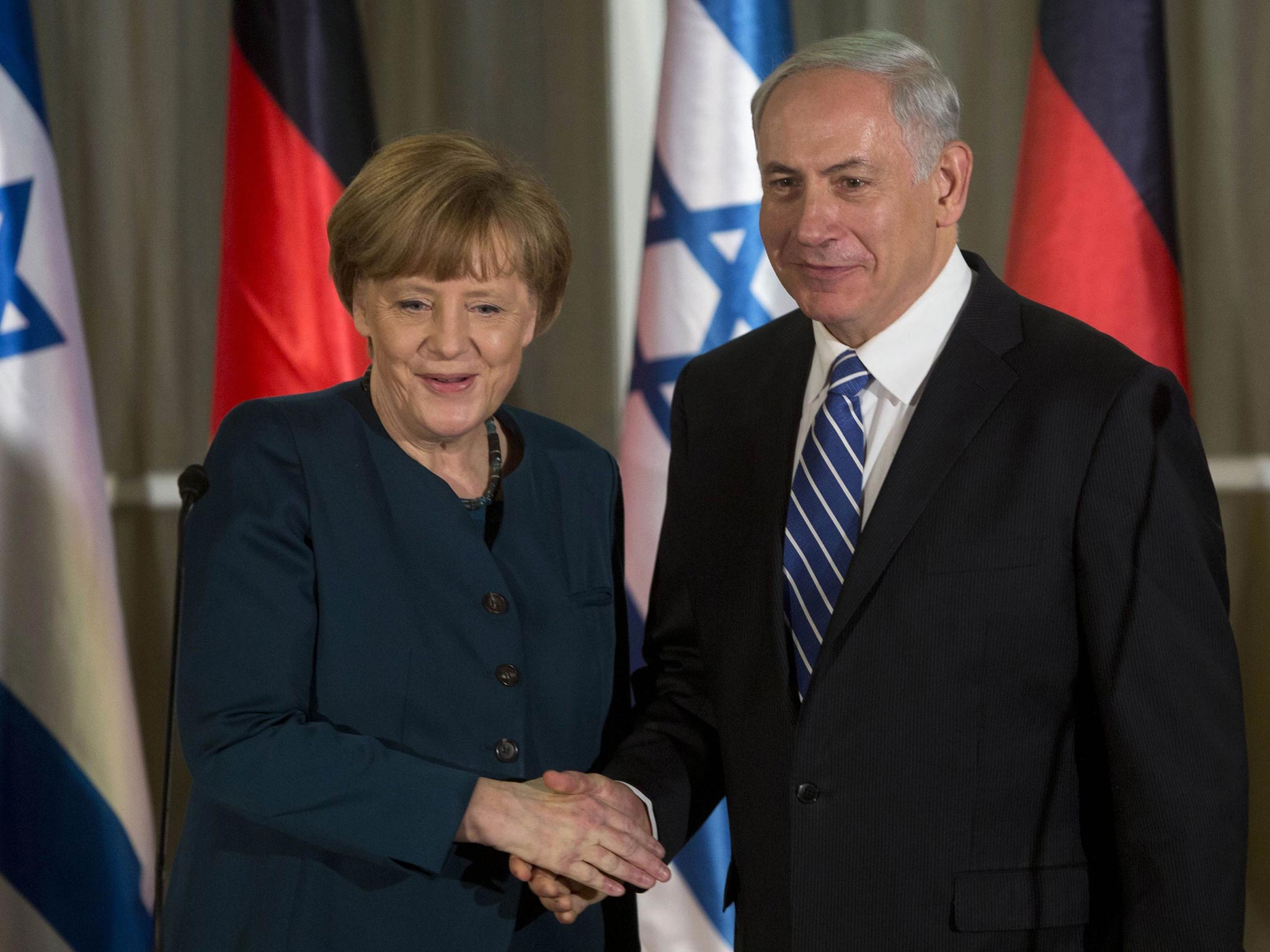 German Chancellor Angela Merkel shakes hands with Israeli Prime Minister Benjamin Netanyahu