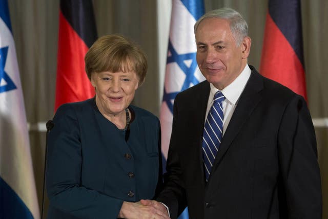 German Chancellor Angela Merkel shakes hands with Israeli Prime Minister Benjamin Netanyahu 