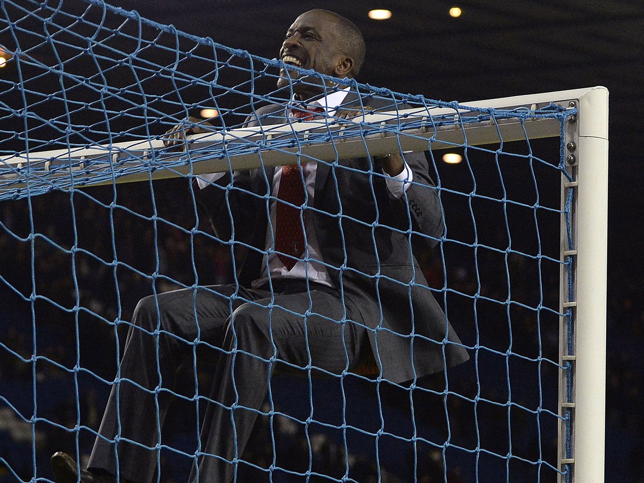 Chris Powell celebrates Charlton's 2-1 FA Cup fifth round victory over Sheffield Wednesday by swinging on the crossbar in front of the celebrating away fans