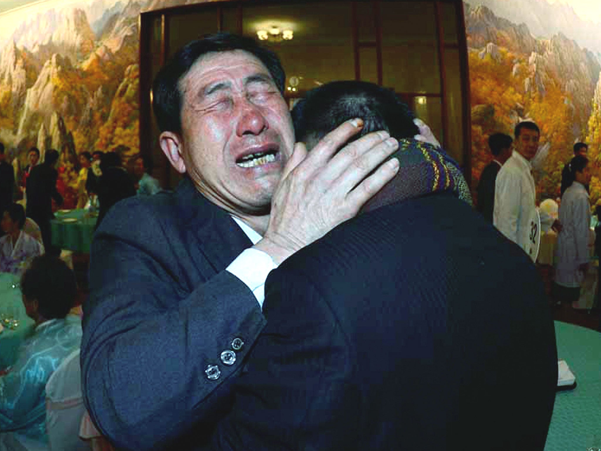 South Korean Park Yang-Gon (L) meets with his North Korean brother Park Yang-Soo during a family reunion after being separated for 60 years in Mount Kumgang