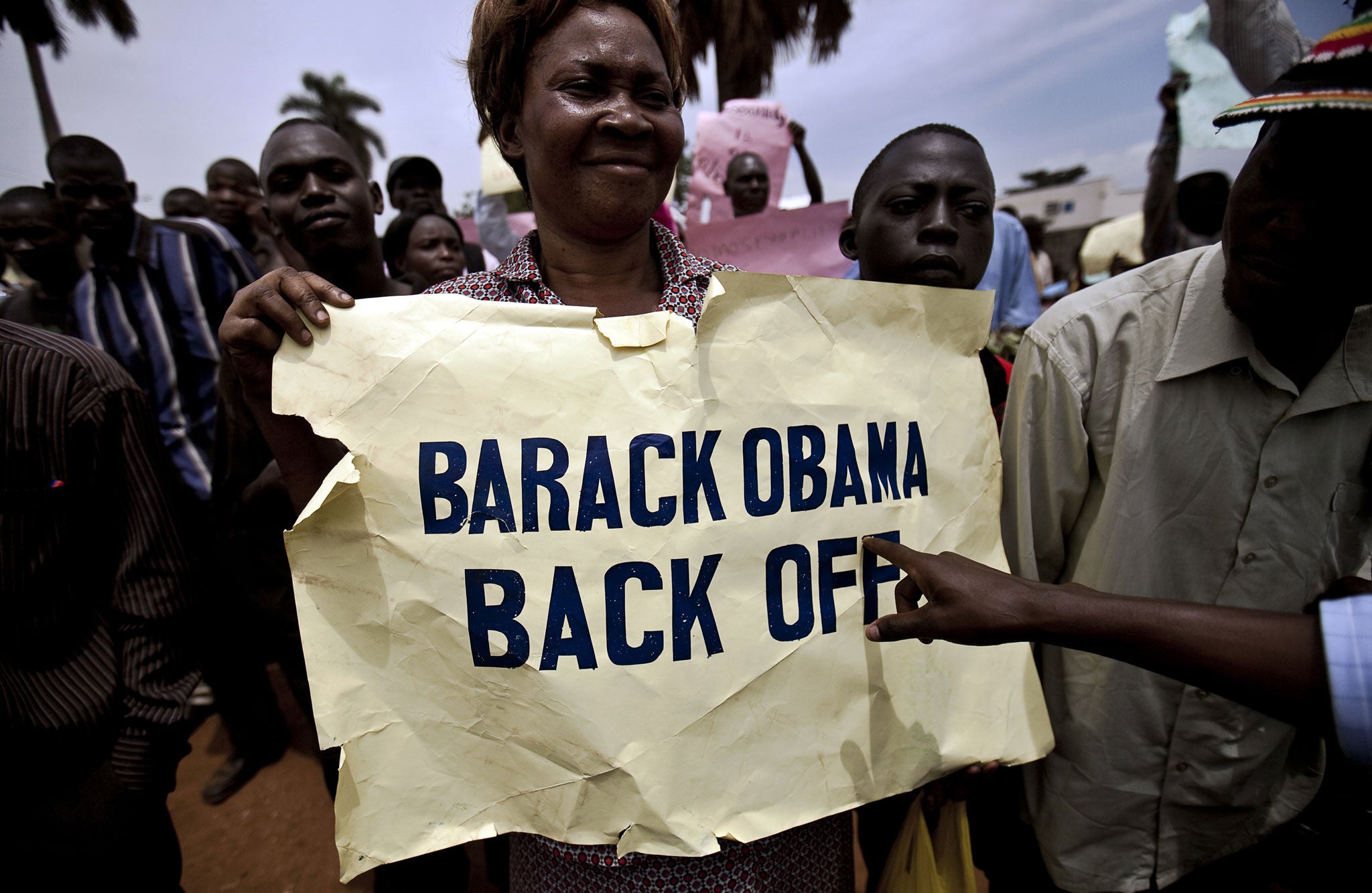 Photo made on February 14, 2010 shows a woman holding a placard as she takes part in an anti-gay demonstration in Jinja, Kampala.