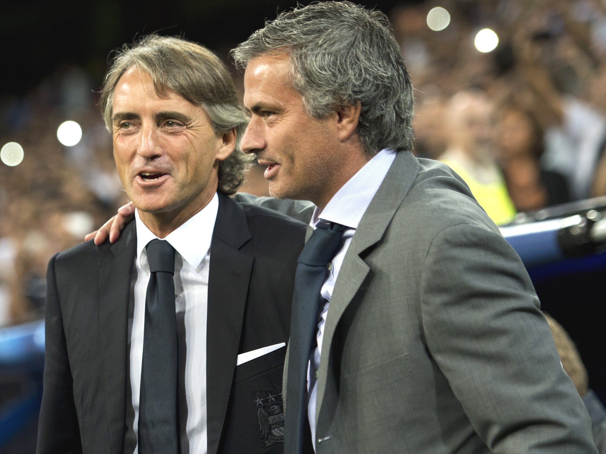Roberto Mancini and Jose Mourinho share a joke during a 2012 Champions League tie between Real Madrid and Manchester City (Getty)