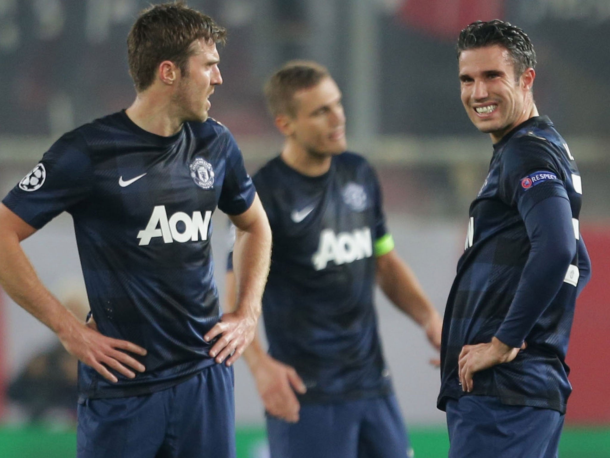 Michael Carrick (left), Nemanja Vidic (centre), and Robin van Persie (right) look on in despair during Manchester United's 2-0 defeat at Olympiakos