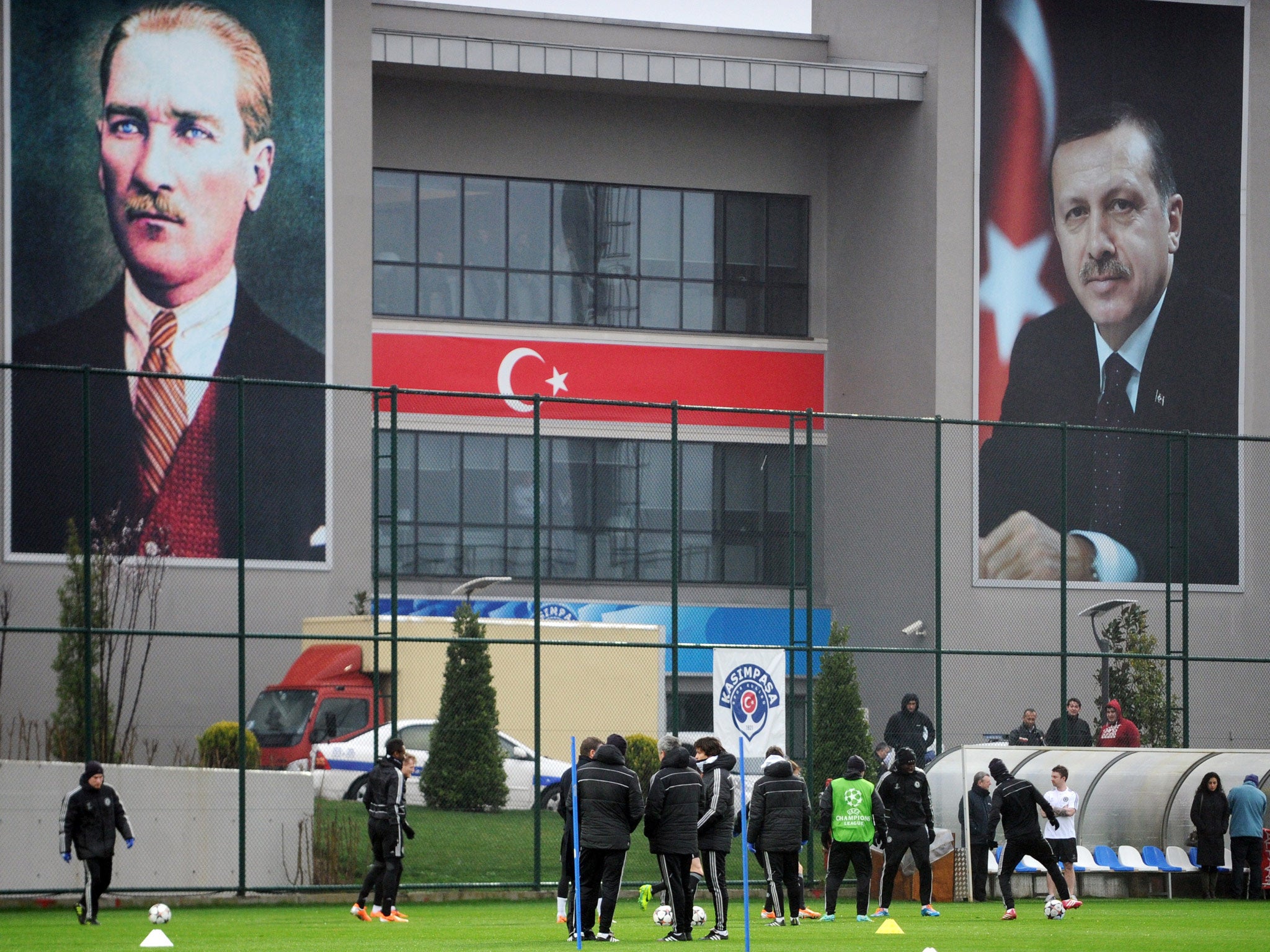 Large posters of Mustafa Kemal Ataturk (L), the late founder of modern Turkey, and of Prime minister Recep Tayyip Erdogan (R) hang on the side of a building as Chelsea players take part in a training in Istanbul