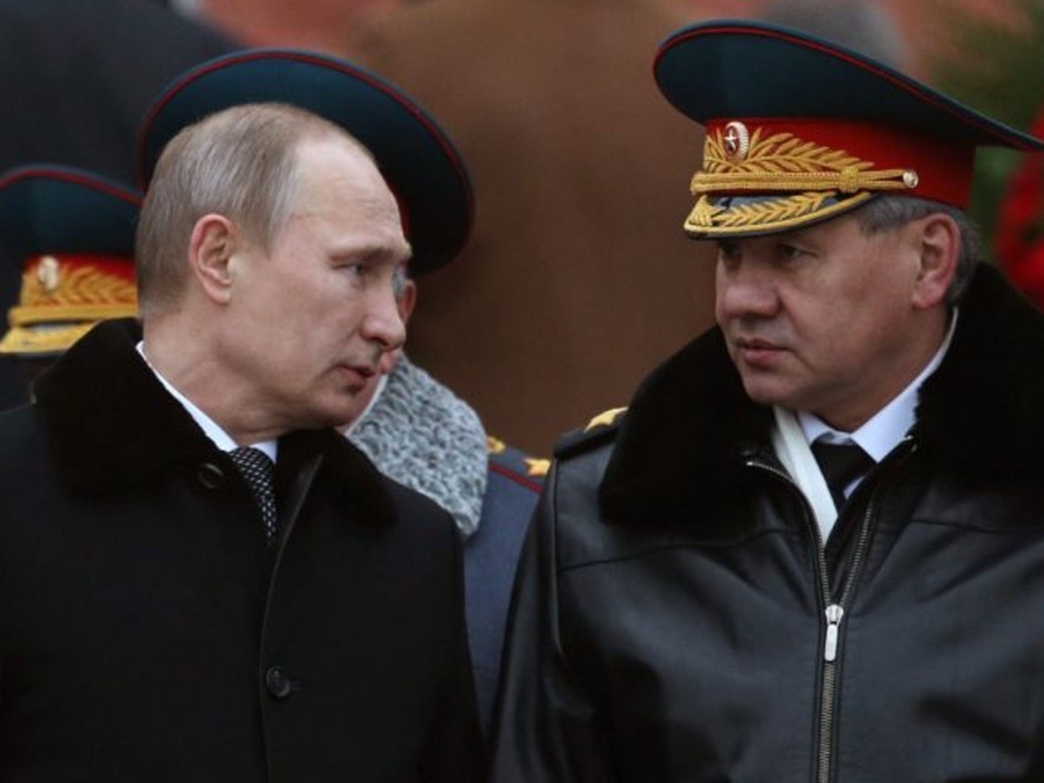Defence Minister Sergei Shoigu (right) announced President Putin's order in a televised statement