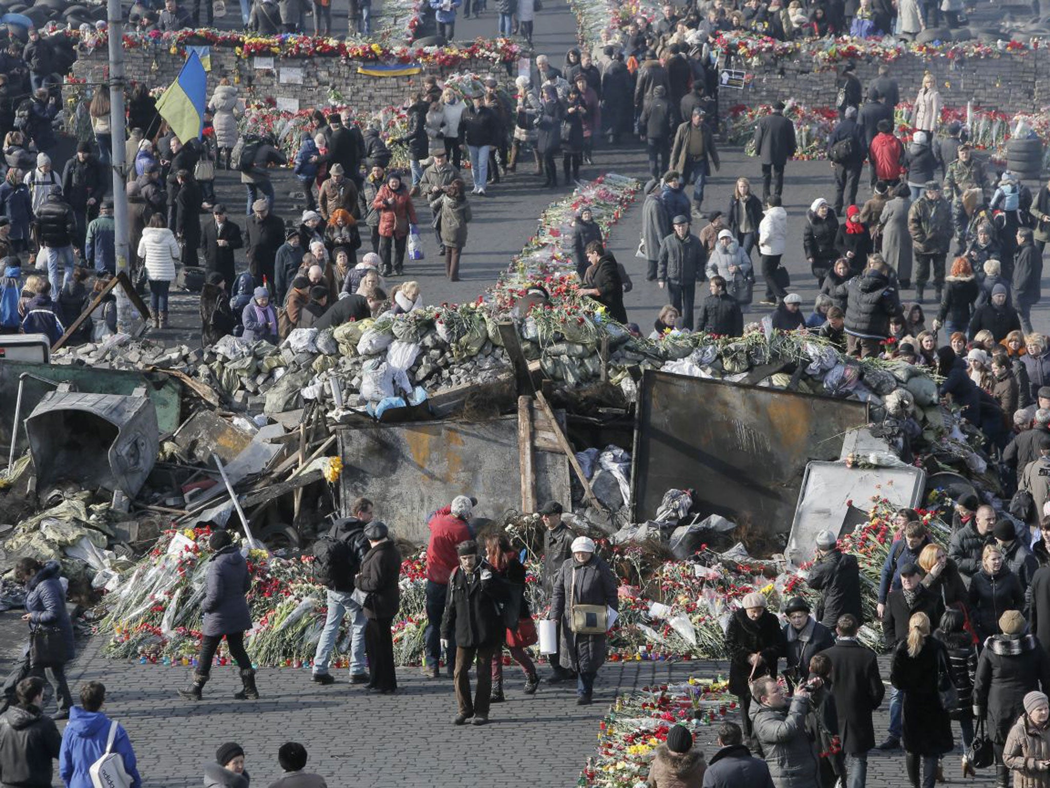Flowers cover the ground and barricades where protesters were killed in a recent clash with riot police in Kiev's Independence Square