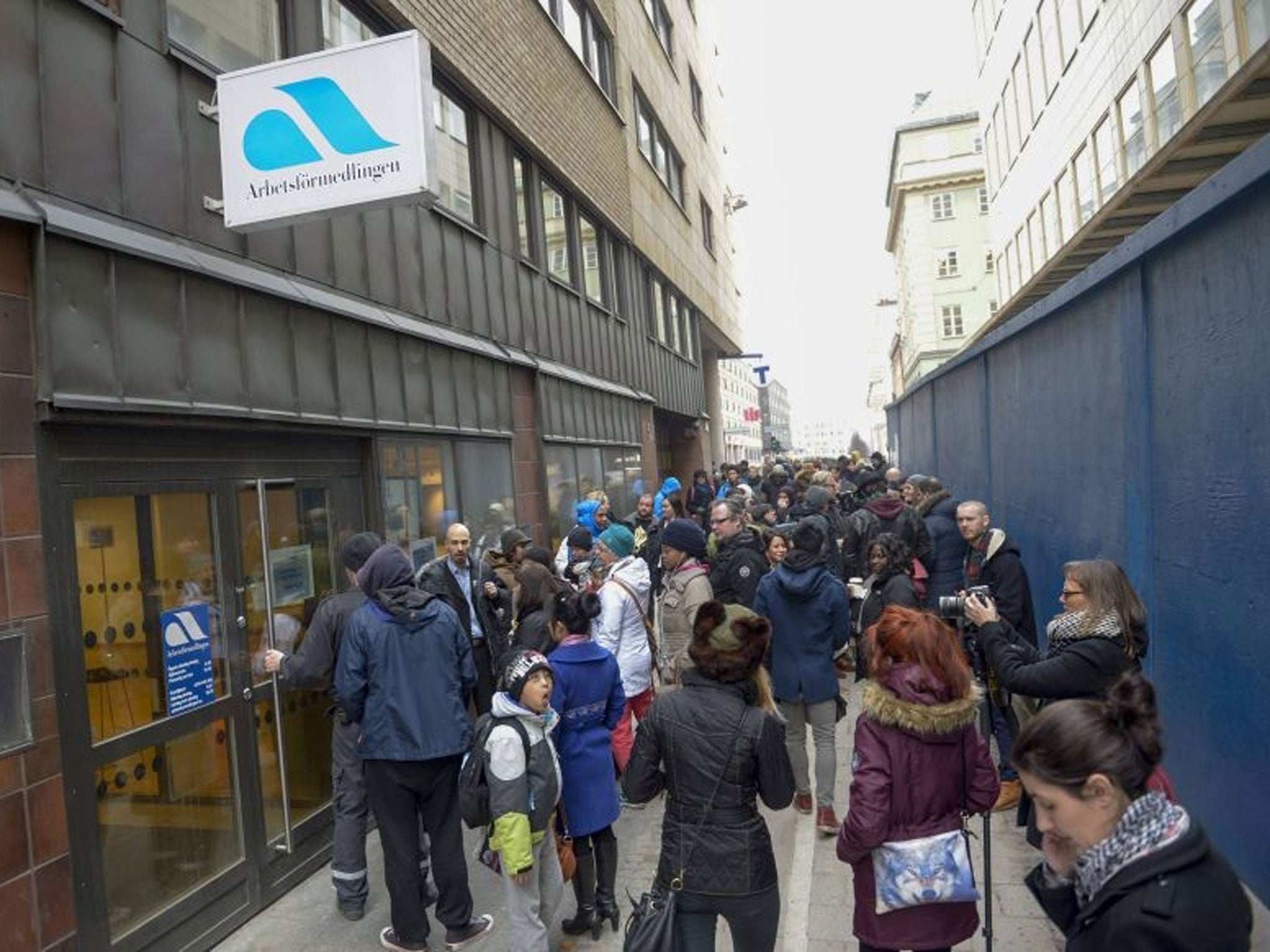 Job-seekers congregate outside the Swedish job centre