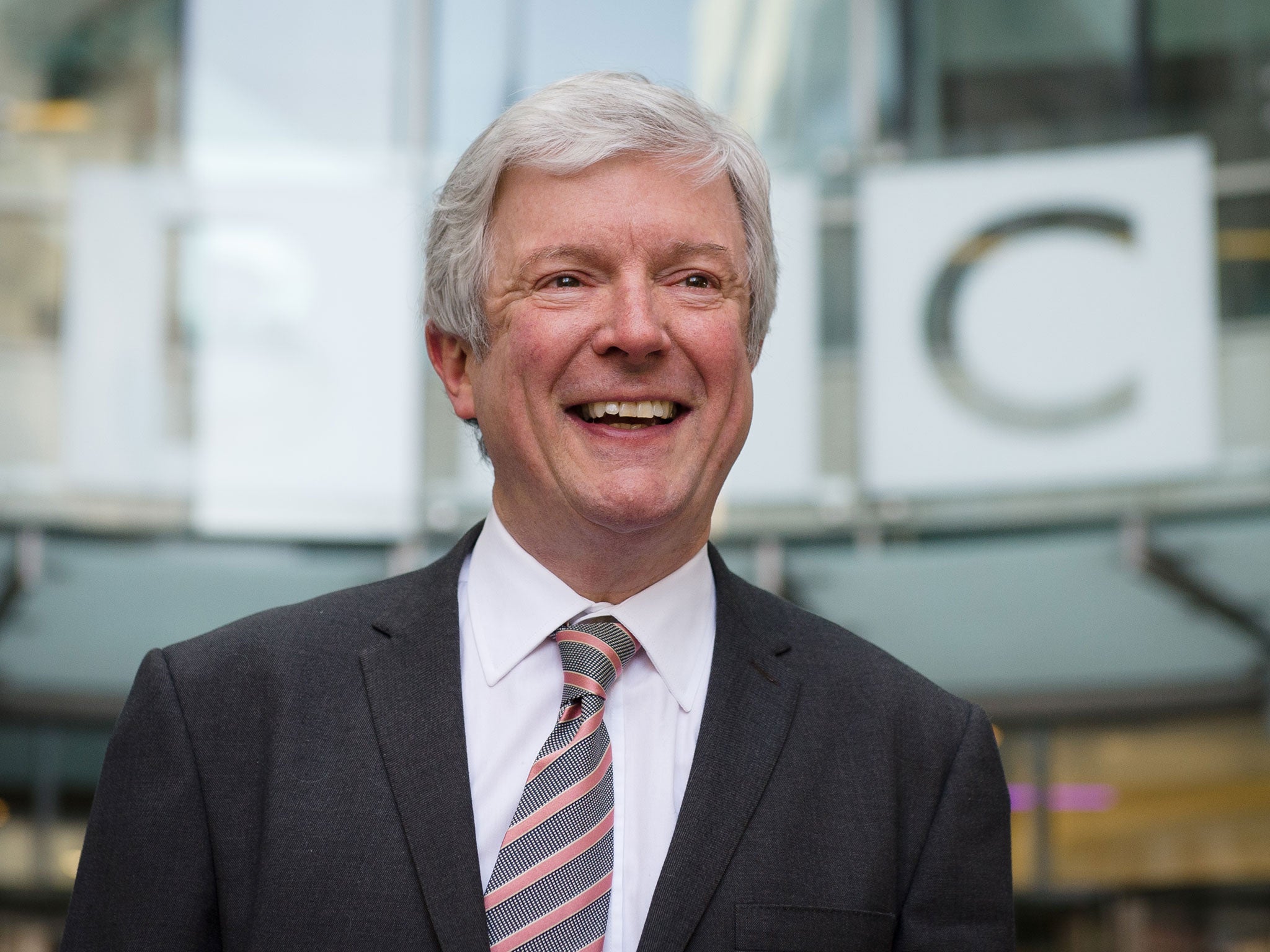 Tony Hall smiles outside New Broadcasting House in central London.