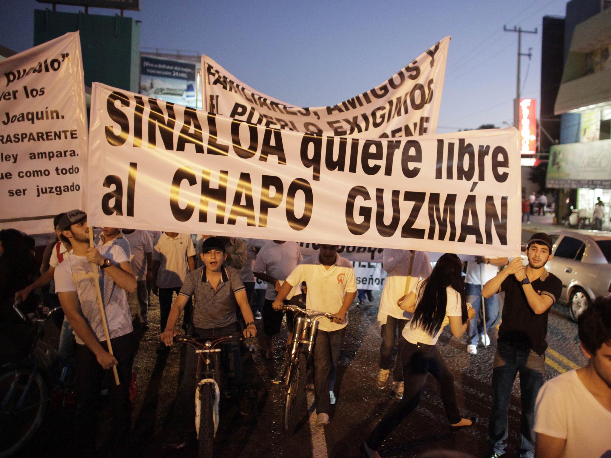 Protesters carry a sign reading, "Sinaloa wants Chapo Guzman free" during a march in Culiacan