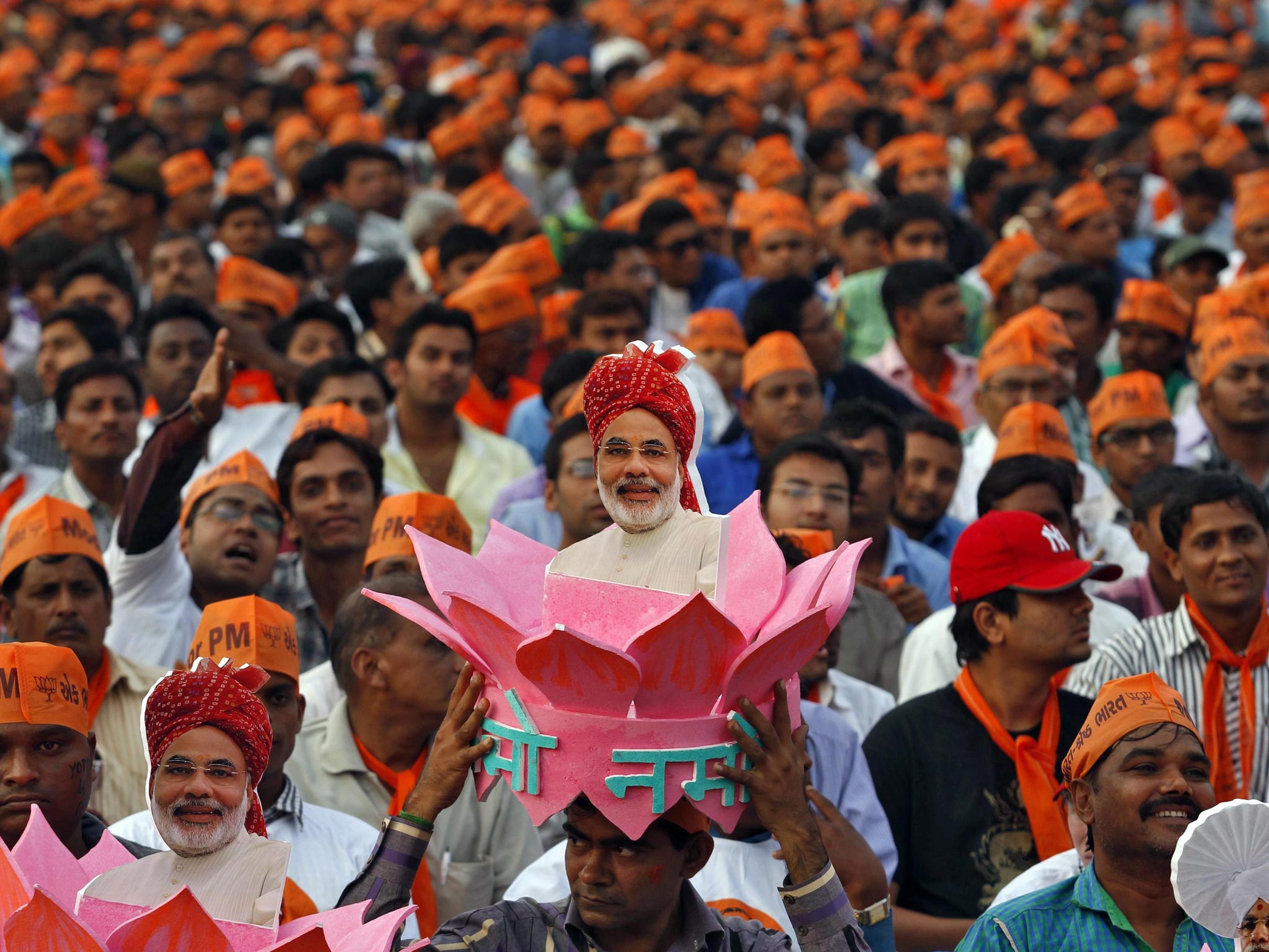 A supporter of Gujarat’s chief minister and Hindu nationalist Narendra Modi, the prime ministerial candidate for India’s main opposition Bharatiya Janata Party (BJP), wears a headgear with a portrait
