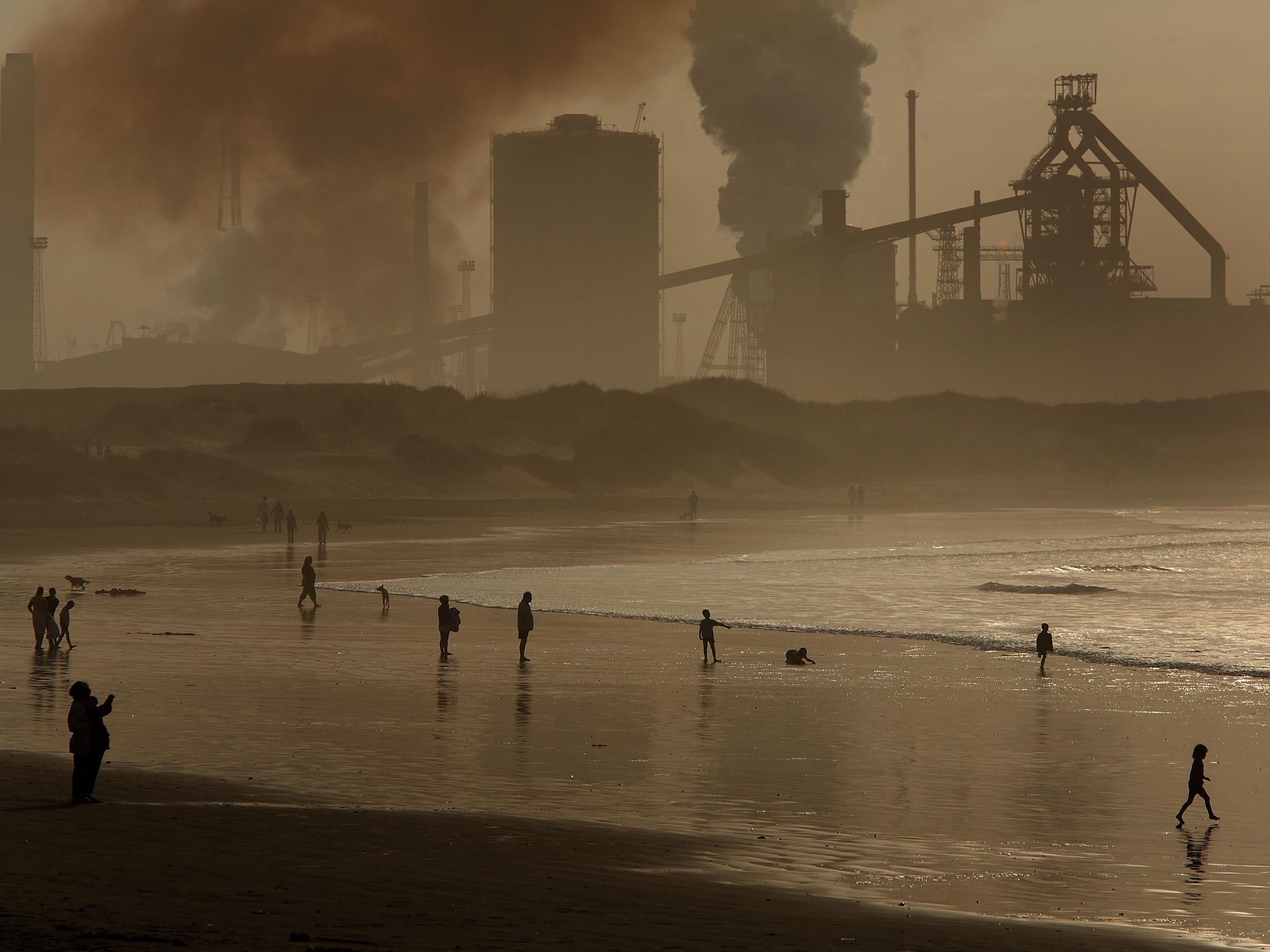 Pea soupers: locals on Redcar beach in the shadow of the Corus Steelworks in Teesside
