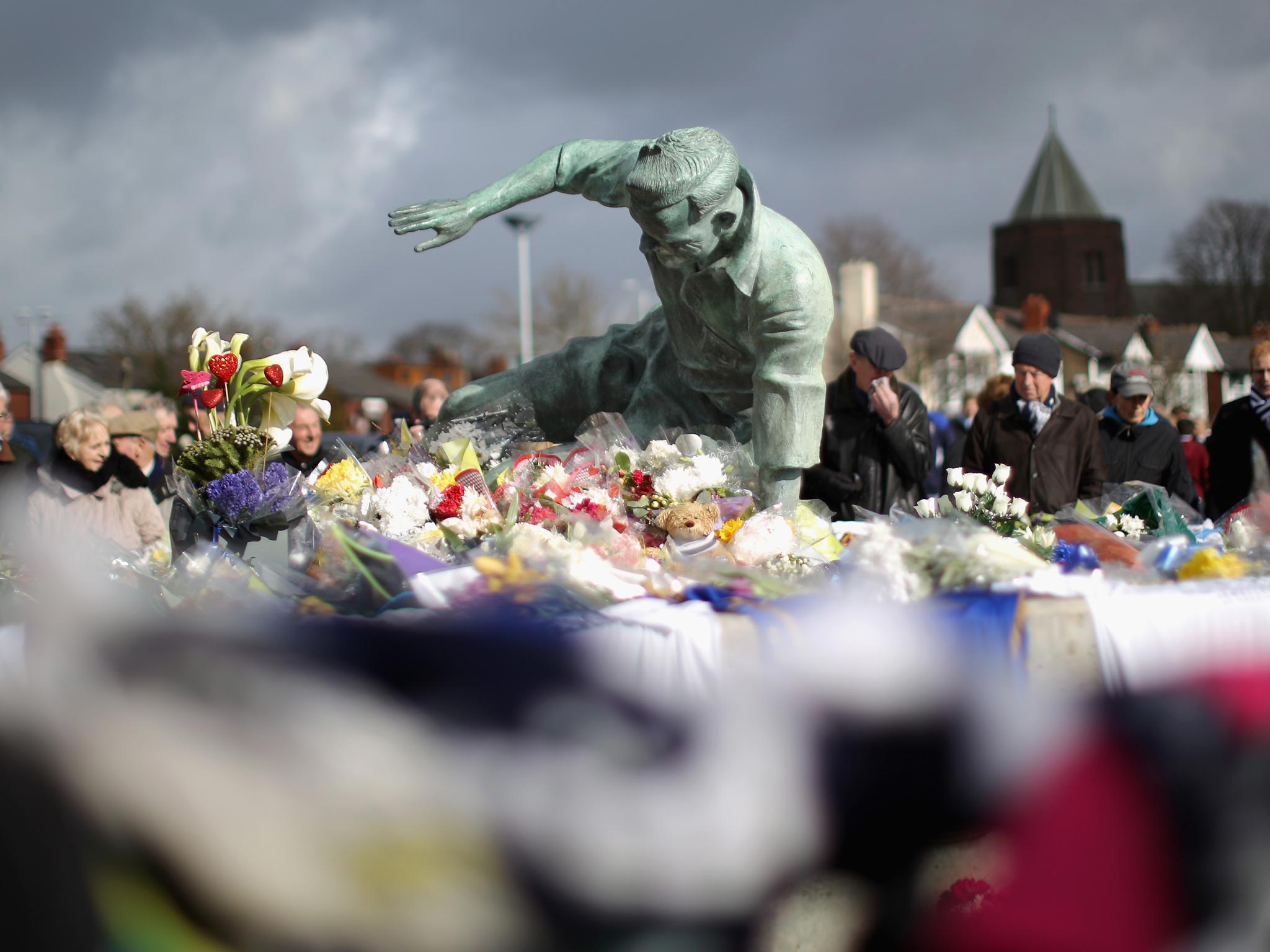 Flowers and tributes adorn the statue of Sir Tom Finney at Deepdale Stadium the home of Preston North End FC