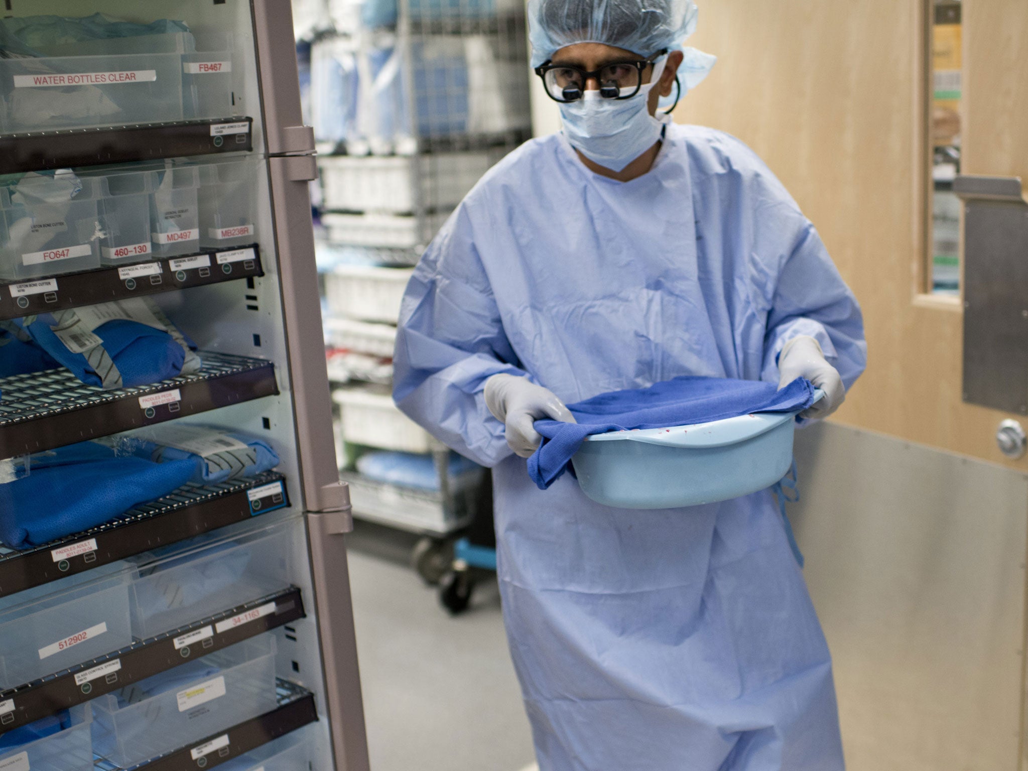 A doctor carries a donor kidney to his patient