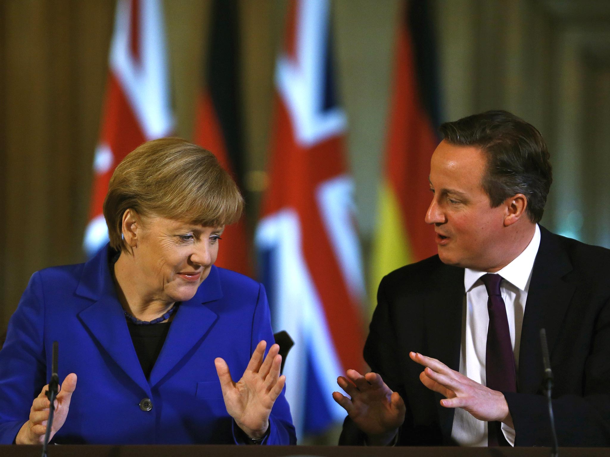 David Cameron speaks during a news conference with German Chancellor Angela Merkel at Downing Street