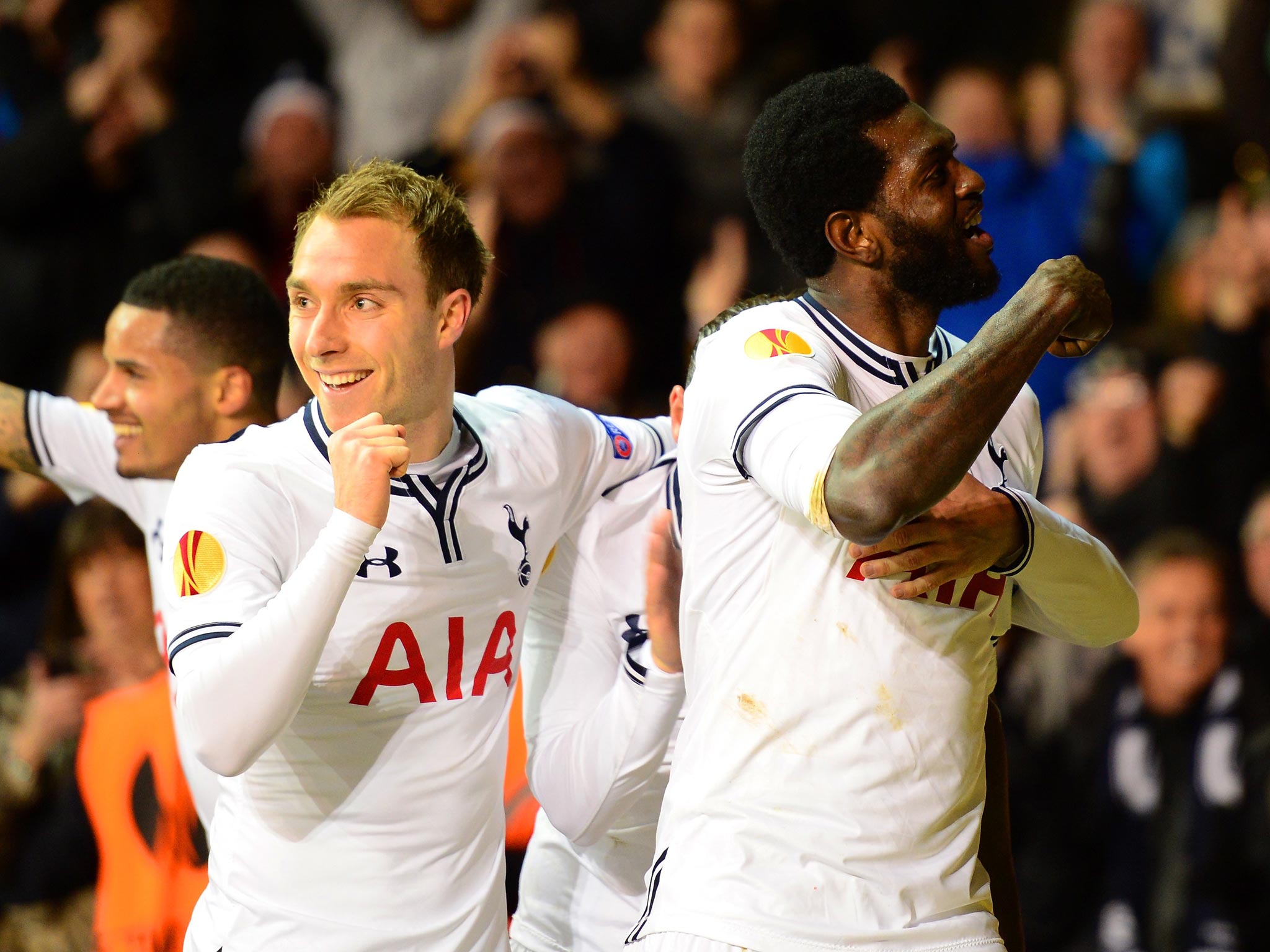Emmanuel Adebayor of Tottenham Hotspur celebrates with team mate Christian Eriksen after scoring a goal