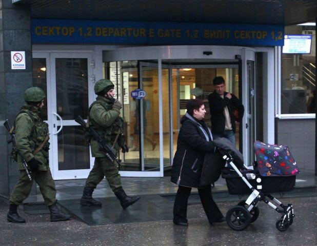 Men carrying rifles patrol at Simferopol airport