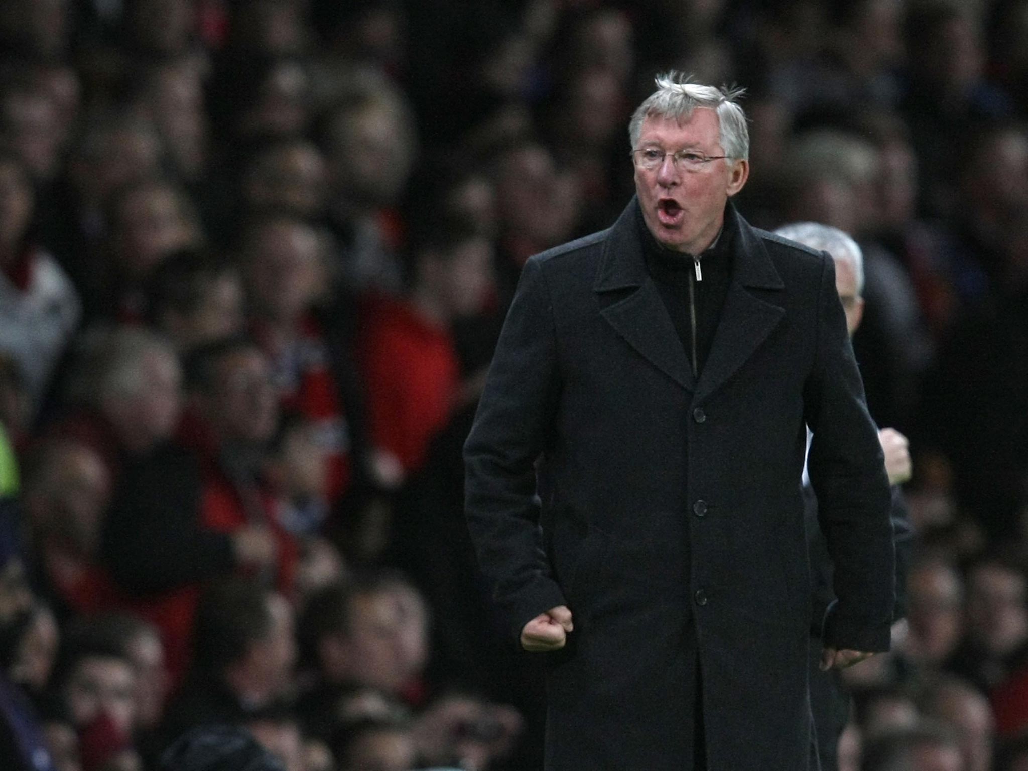 Sir Alex Ferguson of Manchester United complains to the assistant referee during the Barclays Premier League match between Manchester United and Newcastle United