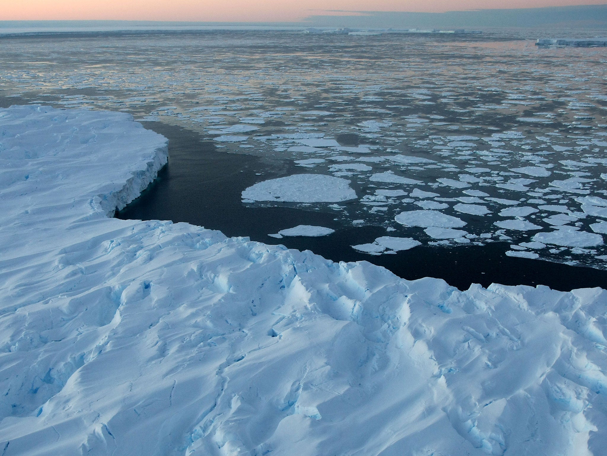 iant tabular icebergs are surrounded by ice floe drift in Vincennes Bay in the Australian Antarctic Territory