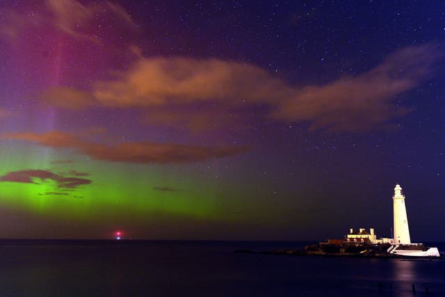 The aurora borealis, or the northern lights as they are commonly known, at St. Mary's Lighthouse and Visitor Centre, Whitley Bay, North Tyneside  