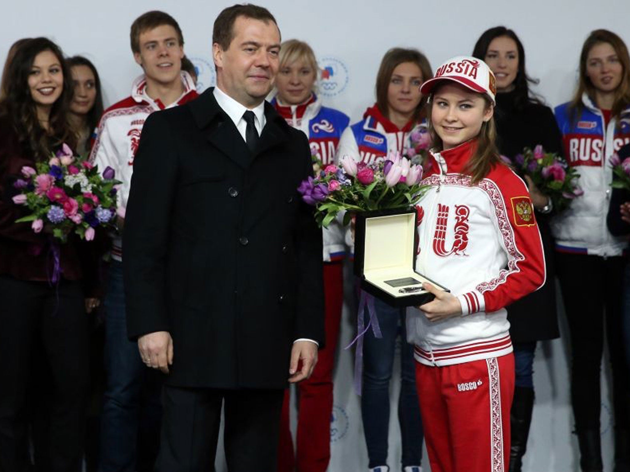 Russian Prime Minister Dmitry Medvedev presents Russian Olympic champion in figure skating Julia Lipnitskaia with a key to a Mercedes-Benz in Moscow