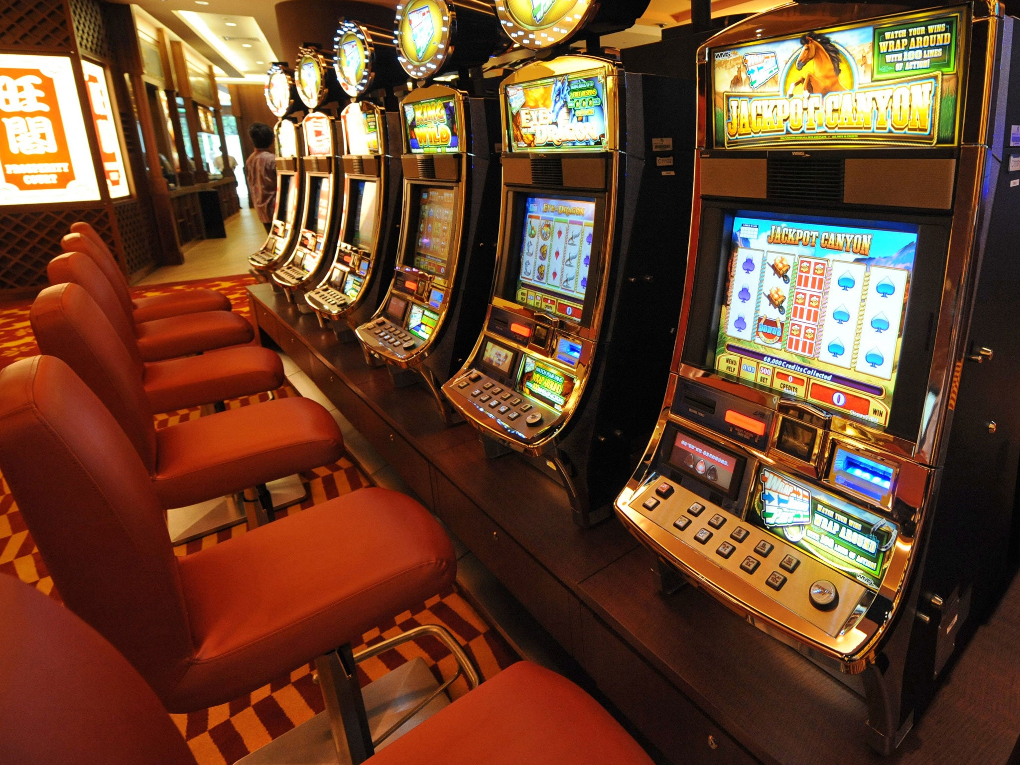 File: A row of slot machines await gamblers at the opening of Singapore's first casino, the Resorts World Sentosa complex, in Singapore