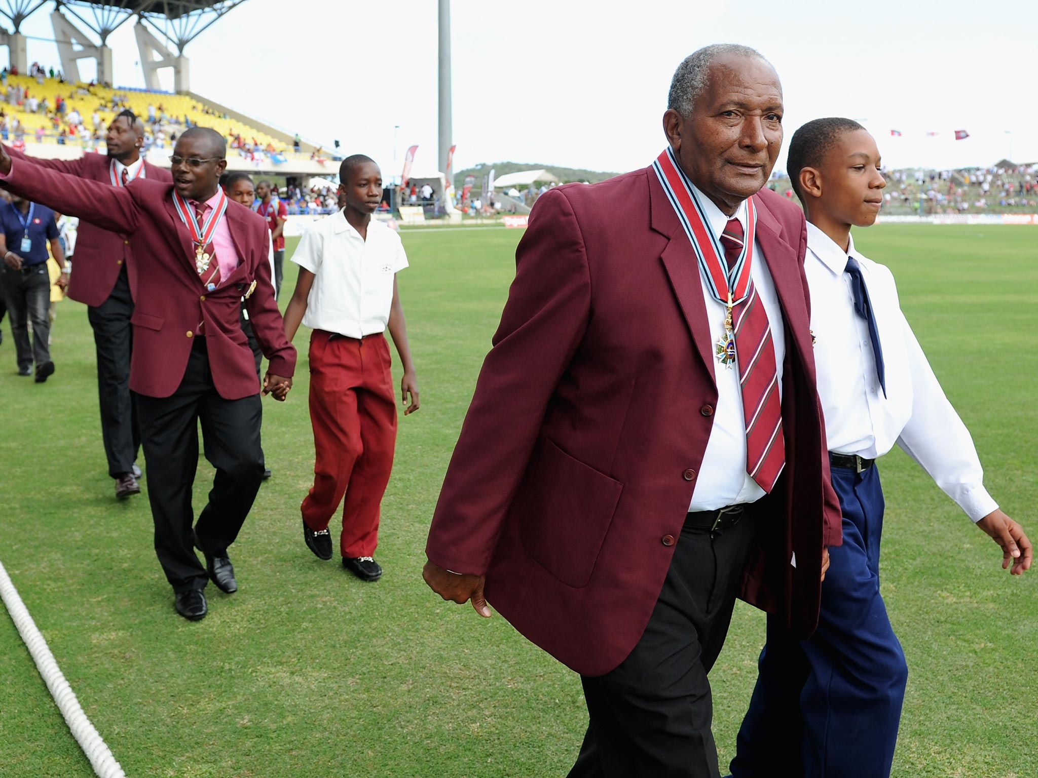 (From right) Andy Roberts, Richie Richardson and Curtly Ambrose are paraded round the field after being awarded knighthoods during the lunch break of the first ODI between West Indies and England in Antigua yesterday
