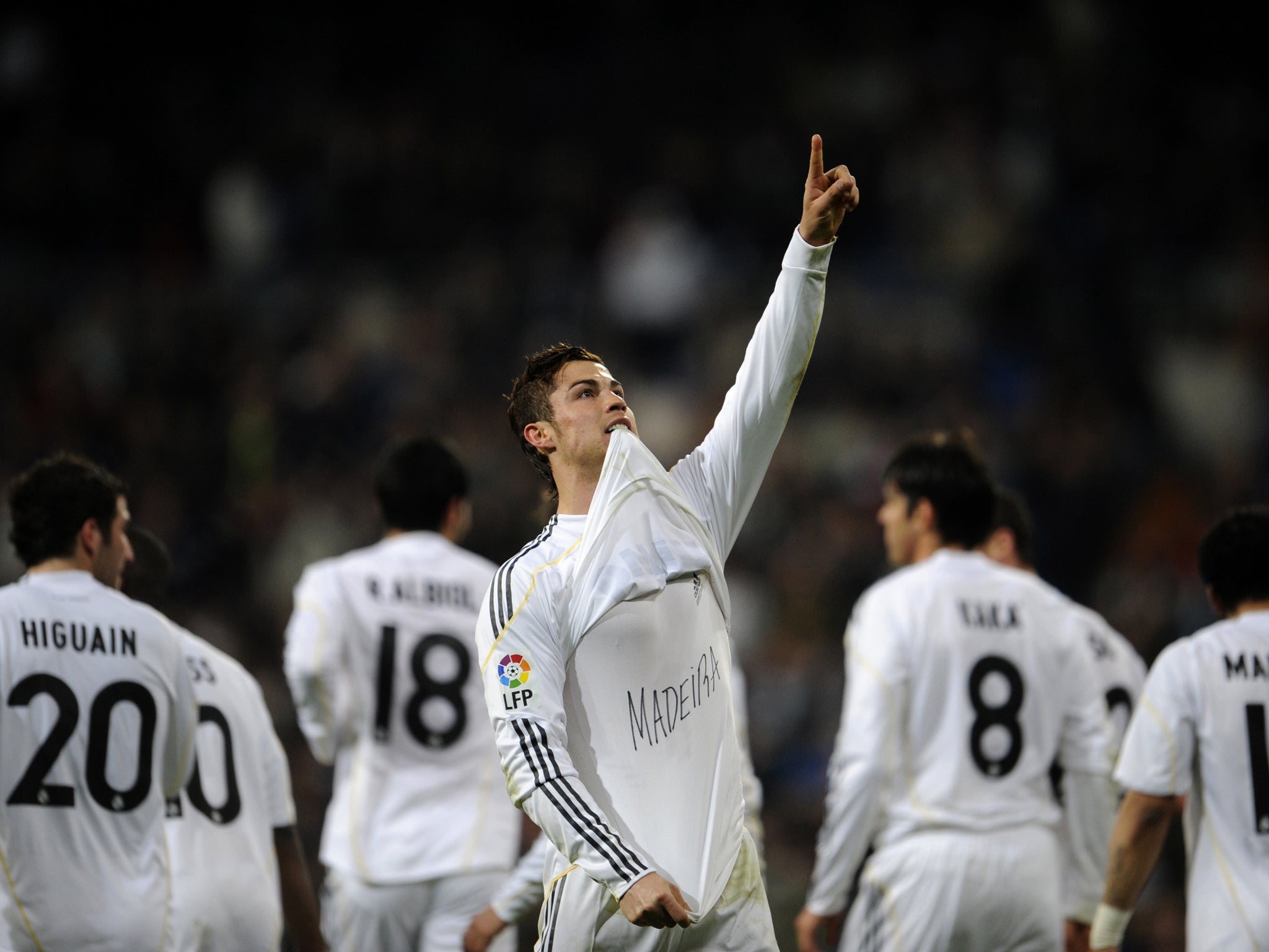 Real Madrid's Portuguese forward Cristiano Ronaldo lifts his jersey to display the name of the island Madeira, written on his shirt, as he celebrates scoring against Villarreal