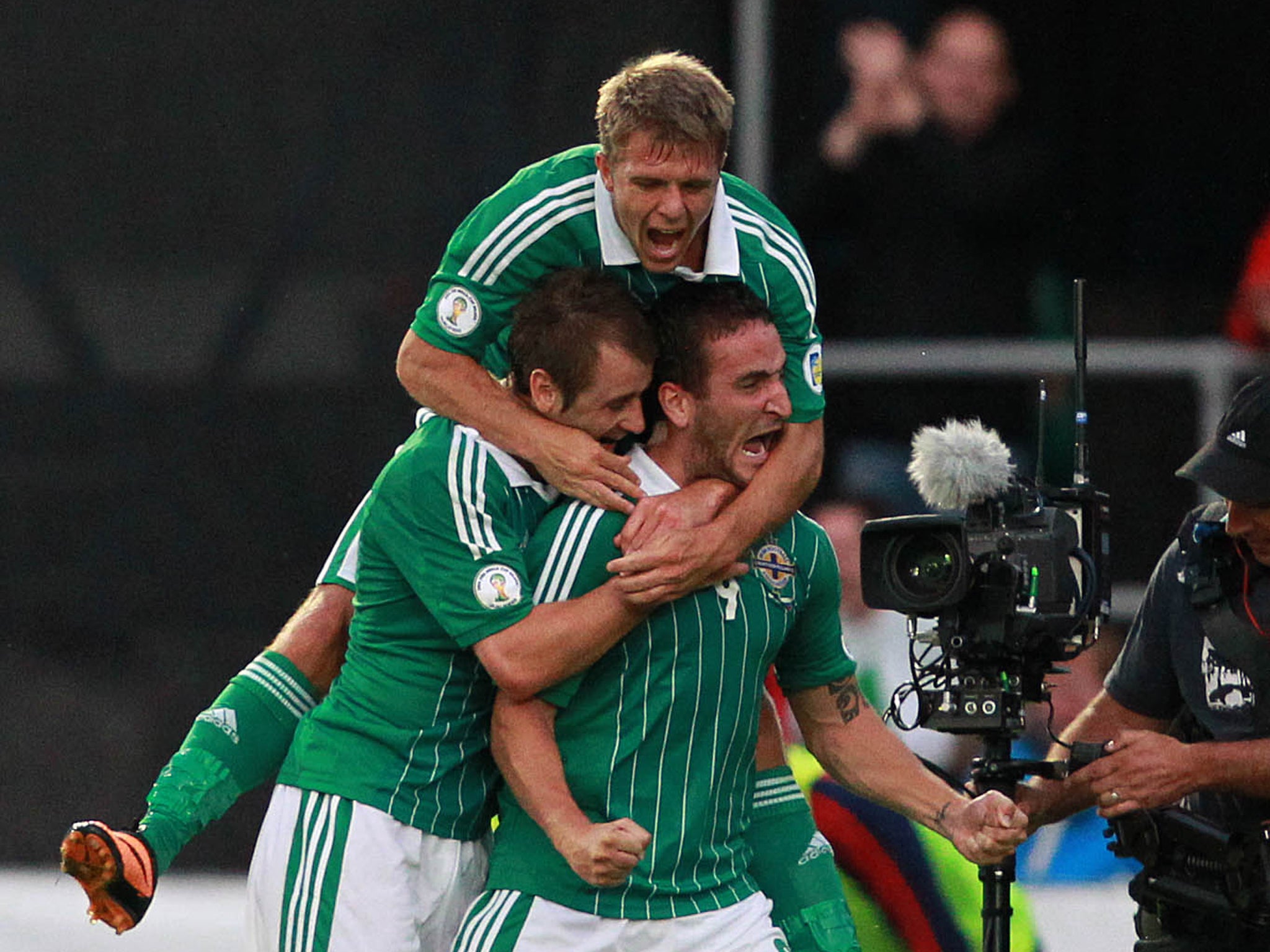 Northern Ireland's Martin Paterson (R) celebrates with team mates after scoring his team's first goal during the FIFA 2014 World Cup European zone group F qualifying football match between Russia and Northern Ireland