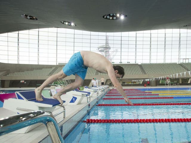 Independent reporter Jamie Merrill dives into the pool at the London Aquatic Centre