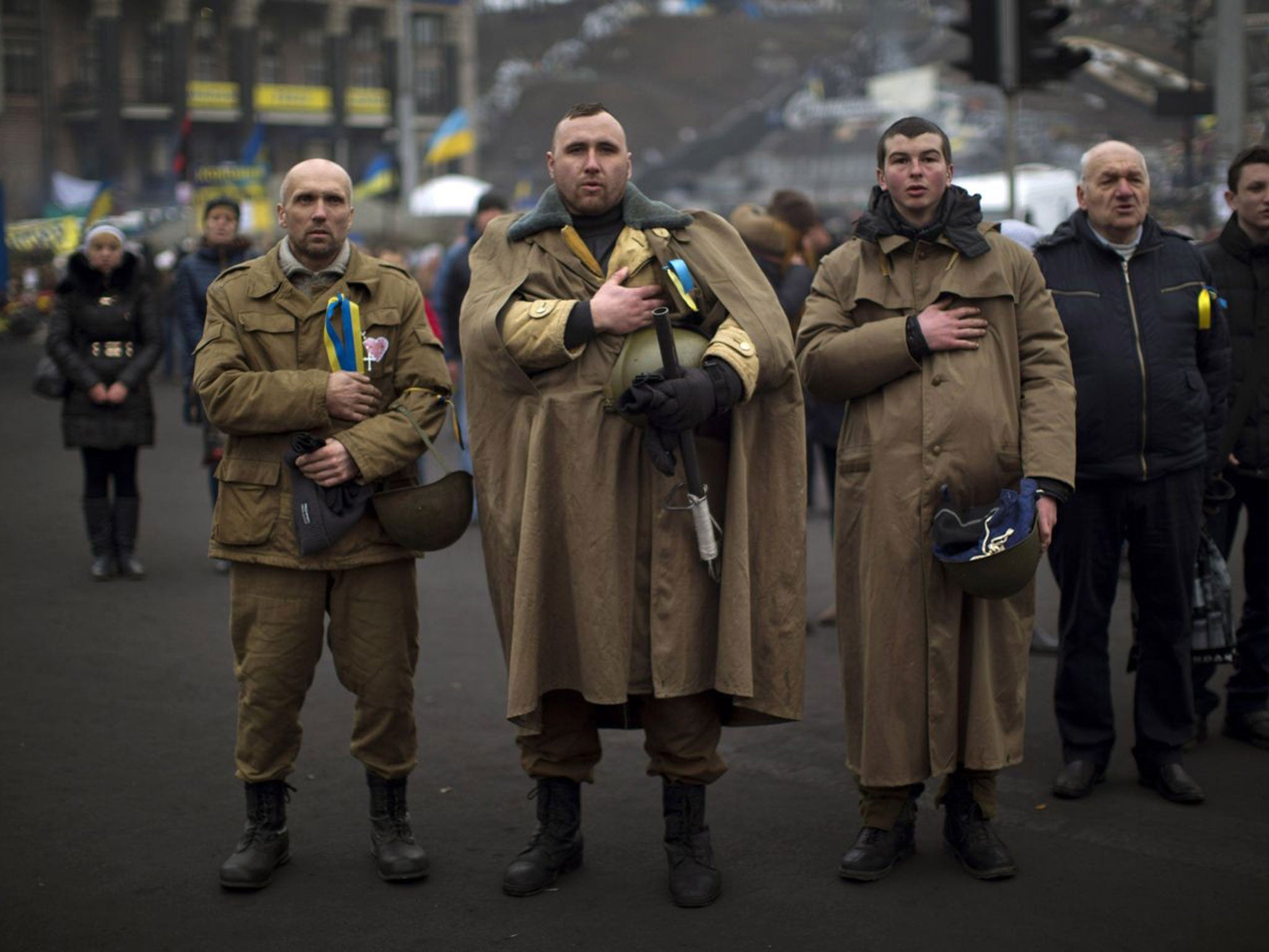 Ukrainians sing their national anthem in Kiev’s Independence Square yesterday